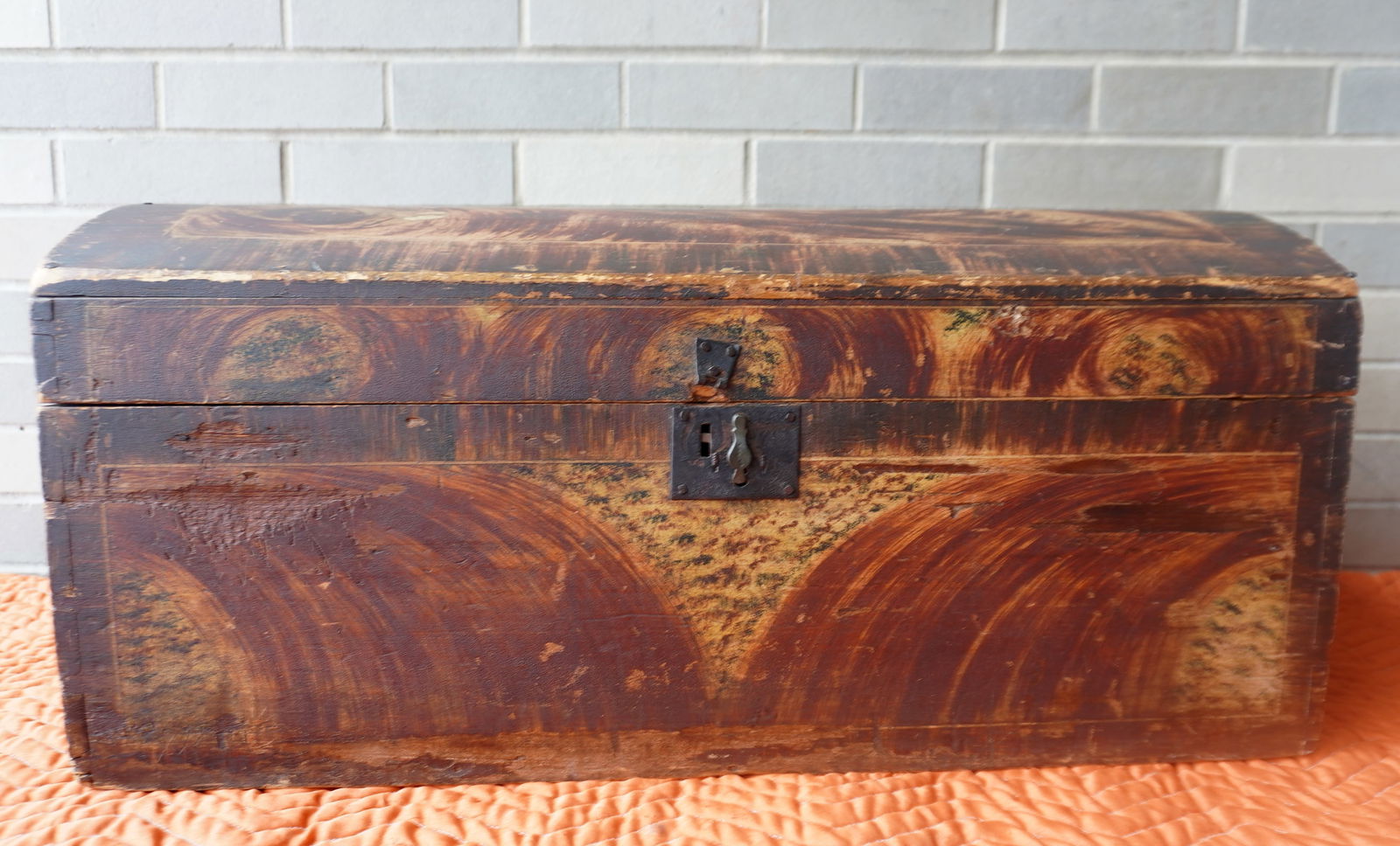 A good New England hand painted and sponge decorated dome top storage box, with pronounced colorful: A good New England hand painted and sponge decorated dome top storage box, with pronounced colorful decorations on front, lid and sides, in mustard, red, and some green paint - dovetailed construction