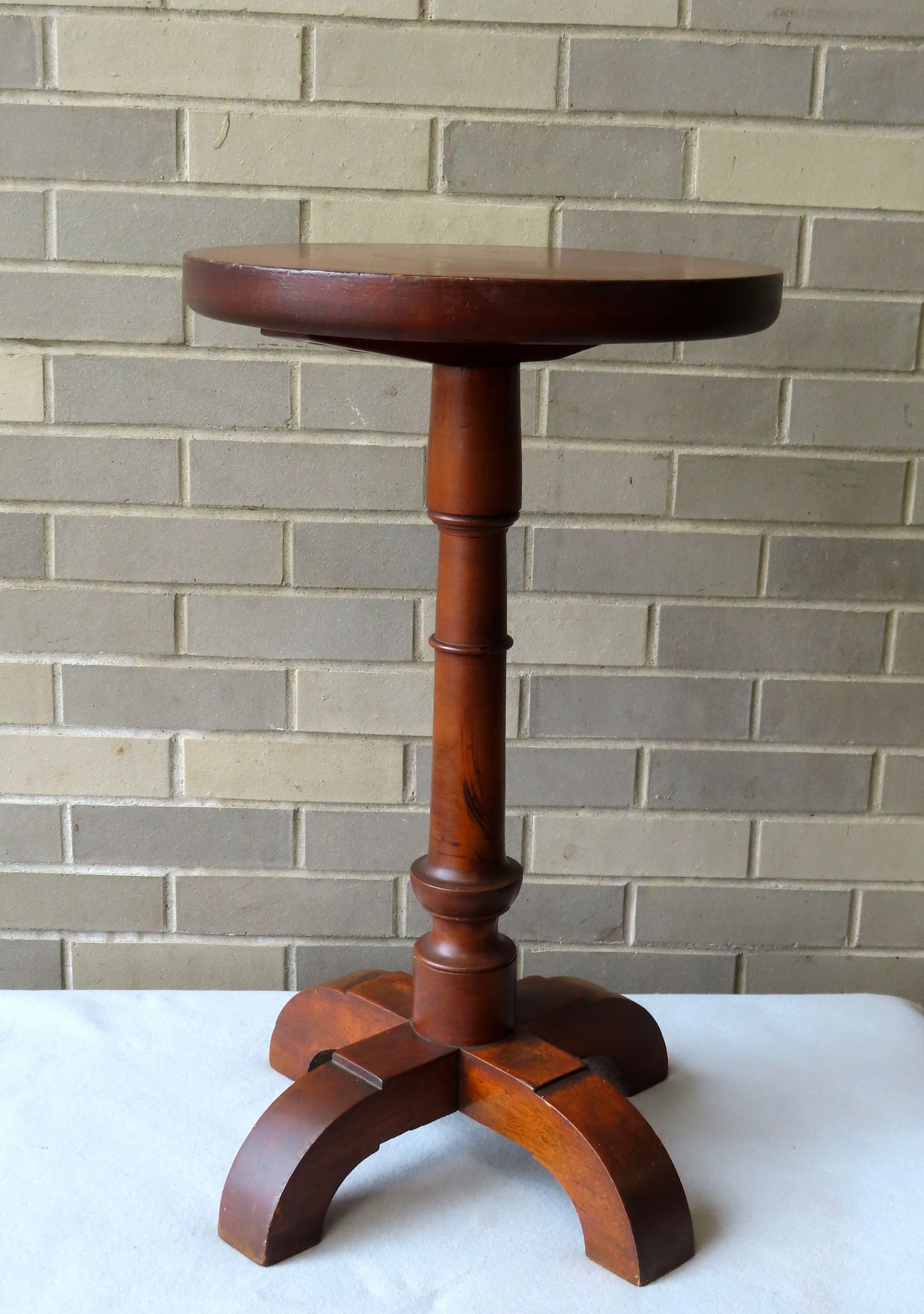 An unusual early candlestand with thick pine top, having a turned cherry base leading to stepped: An unusual early candlestand with thick pine top, having a turned cherry base leading to stepped spider legs, early 19th century and in very good condition. Measures 15" diameter x 25"H.