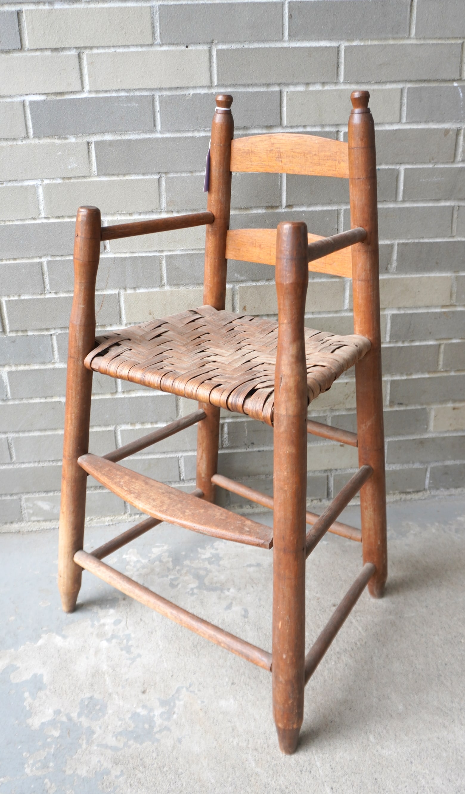 An early child's high chair with turned stiles and arms and with button finials and turned splayed (1 of 1)