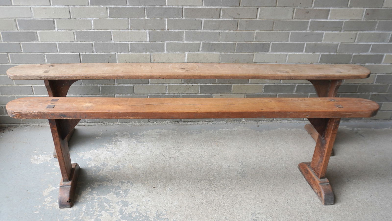 Two narrow wooden benches with shoe-feet and see-through mortised construction, early 19th century,: Two narrow wooden benches with shoe-feet and see-through mortised construction, early 19th century, probably French and traditionally used as an entrance hall bench for taking off or putting on boots