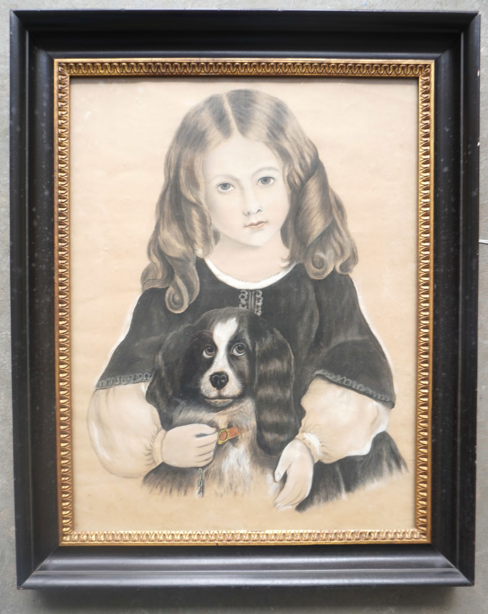 A beautiful pastel portrait of a young girl holding her Spaniel dog wearing collar, circa 1860-80.: A beautiful pastel portrait of a young girl holding her Spaniel dog wearing collar, circa 1860-80. Housed in a painted frame with gilded inset, but unsure of age. The portrait appears in very good con