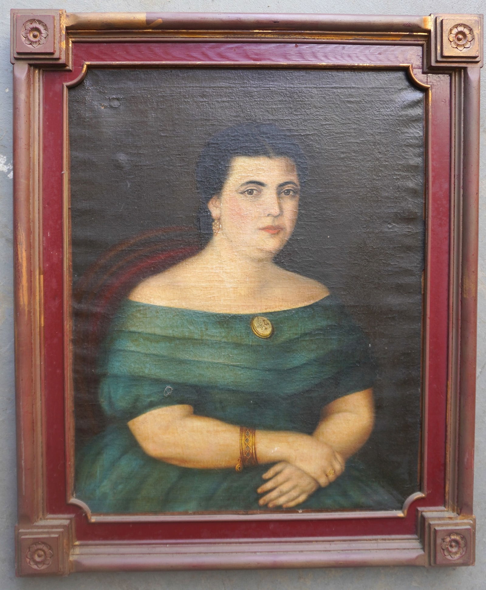 An O/C portrait of lady wearing brooch on turquois colored dress, also wearing earrings and a gold: An O/C portrait of lady wearing brooch on turquois colored dress, also wearing earrings and a gold bracelet, circa 1830-1850. Housed in a very fine 19th century carved wooden frame with rosettes in ea