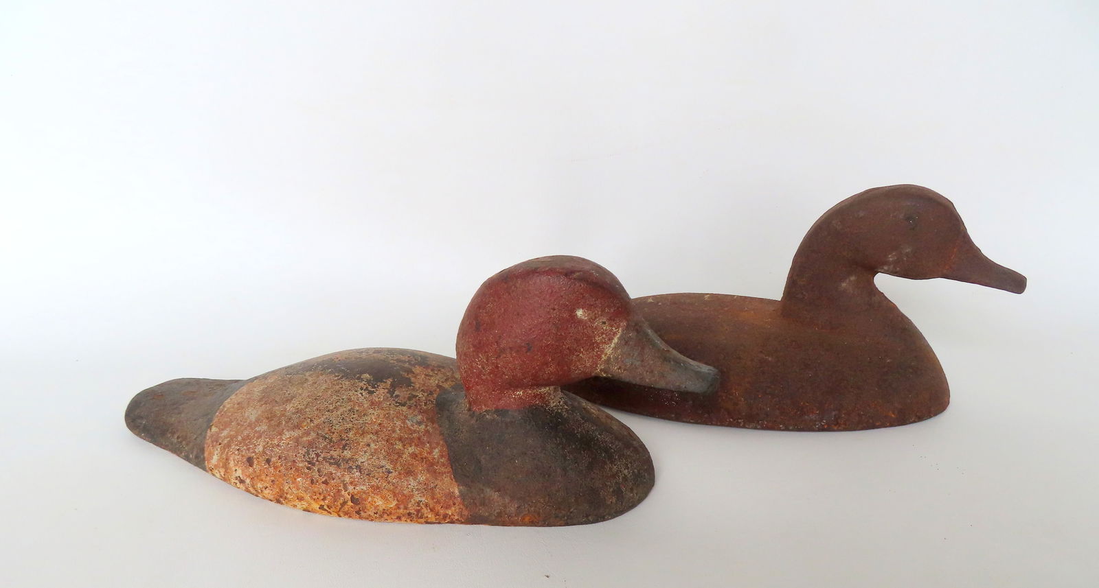 Two sink box cast iron decoys, including a Red Head drake with traces of original paint, and another (1 of 10)