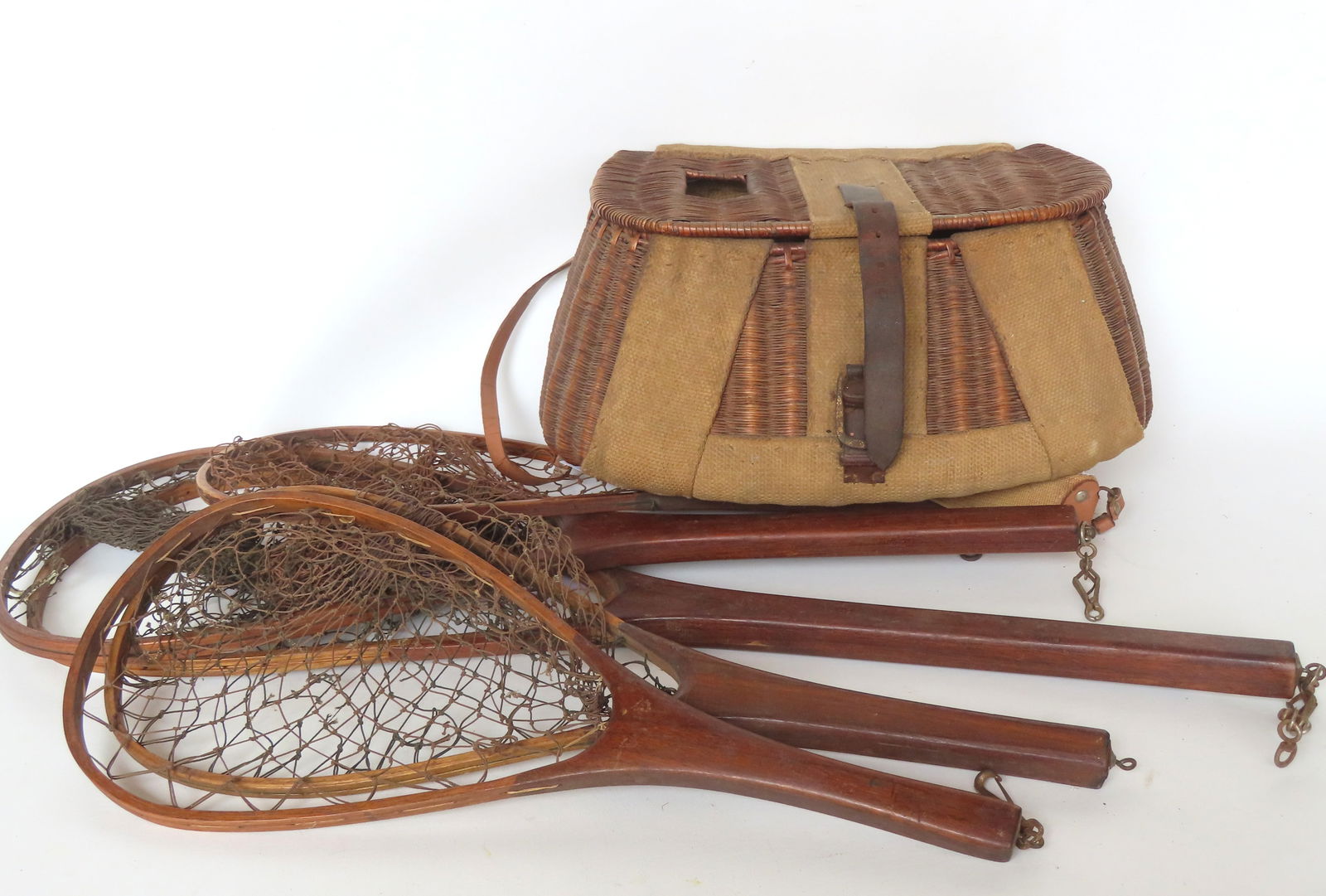 Grouping of 5 vintage hand made fishing nets, together with a very fine early wicker fishing creel: Grouping of 5 vintage hand made fishing nets, together with a very fine early wicker fishing creel with thick fabric supports hand sewn to the creel and signed "F. S. Doremus 1923". All 5 of the fishi