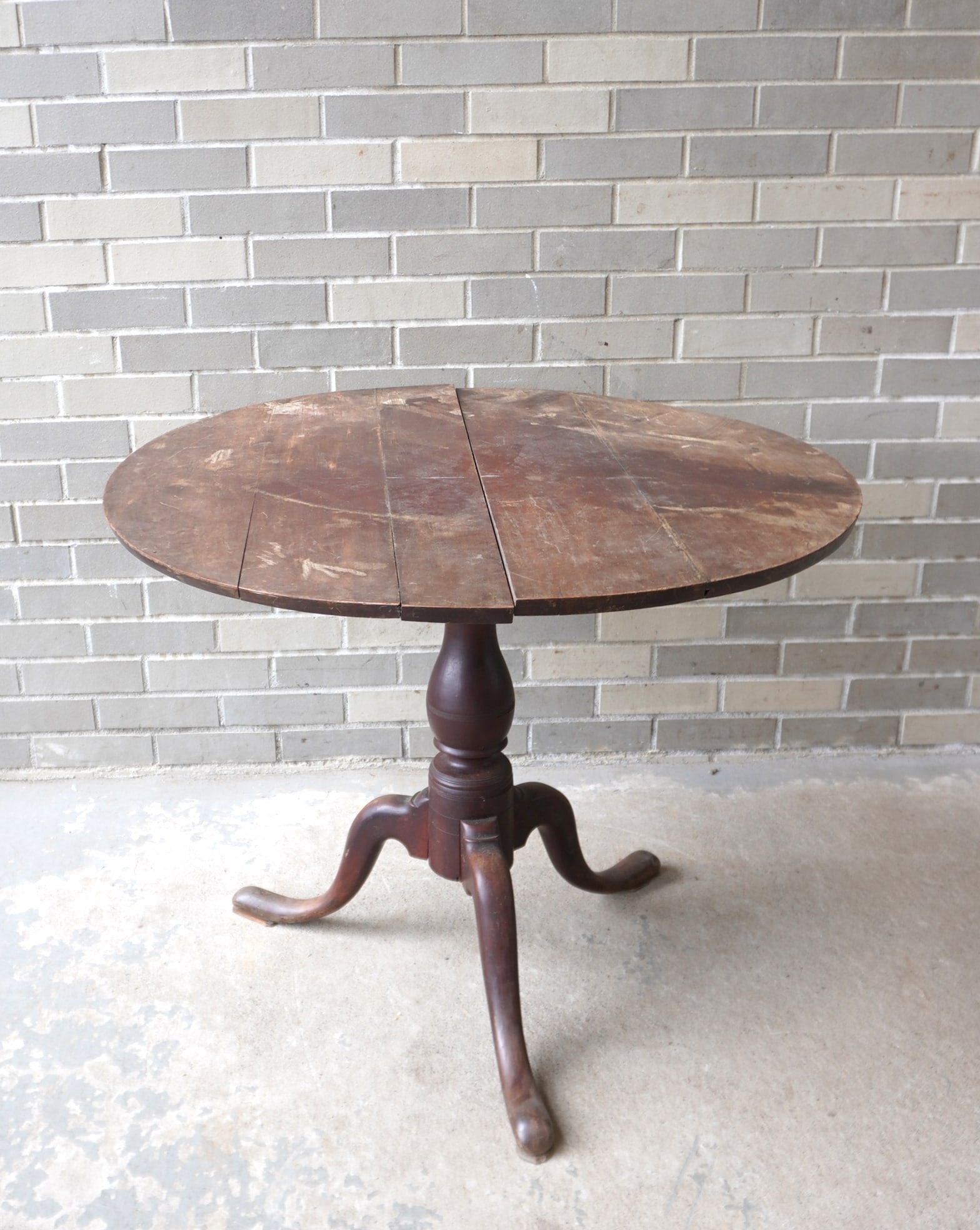 American Queen Ann cherry tilt-top tea table with birdcage attached to turned pedestal leading to: American Queen Ann cherry tilt-top tea table with birdcage attached to turned pedestal leading to pad feet, mid 18th century. The top needs work as some separation in boards that form the top - the pe