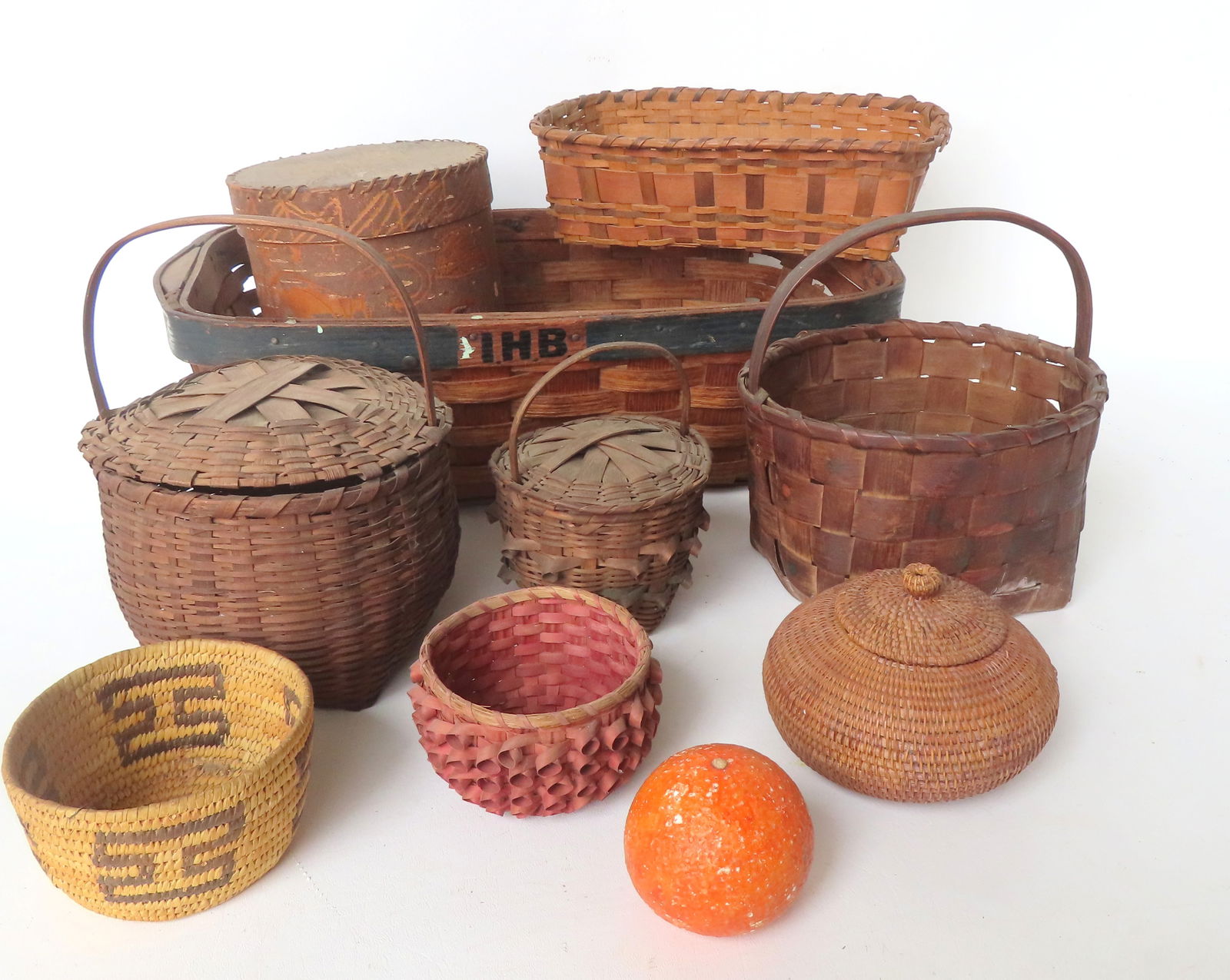A grouping of 9 mostly Native American baskets including a good primitively decorated white birch (1 of 17)