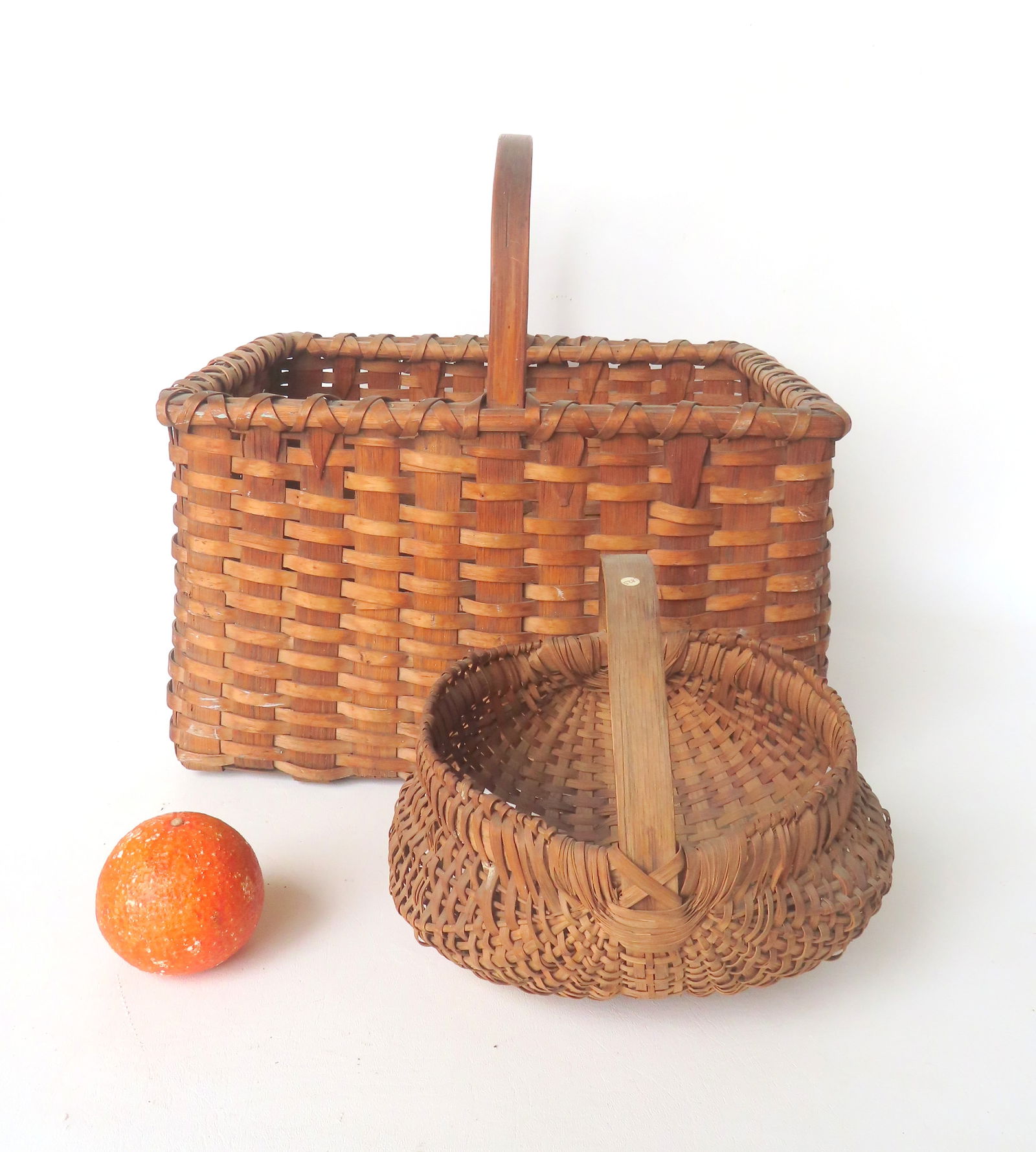 Two early splint baskets, 19th century, including: The first a rectangular shaped market basket with (1 of 12)