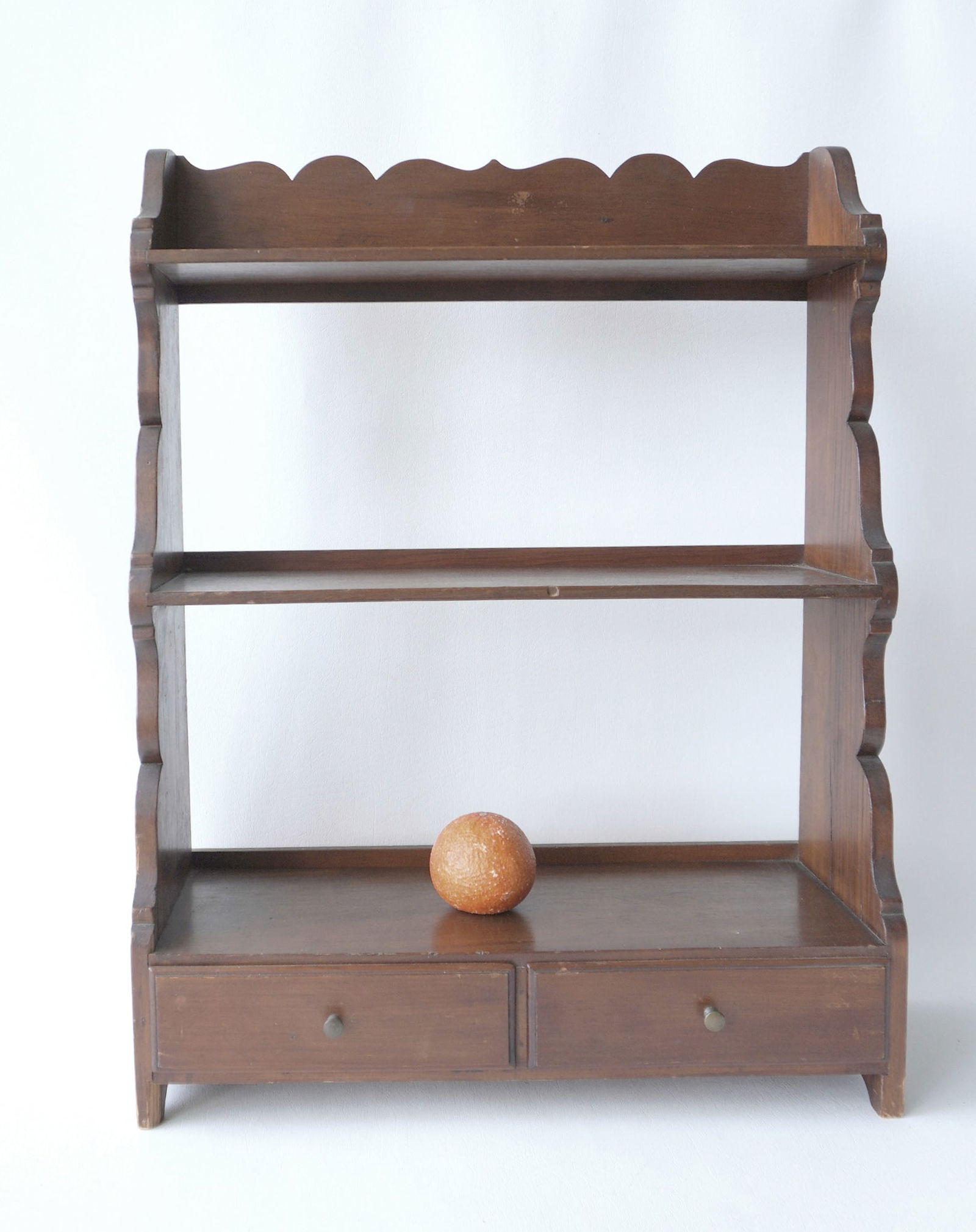 A good country wall shelf with shaped sides, scalloped backsplash and 2 lower hand dovetailed and: A good country wall shelf with shaped sides, scalloped backsplash and 2 lower hand dovetailed and chamfered drawers - mid to late 19th century. Measures 20 1/2"W x 27"H x 7 1/2"D.