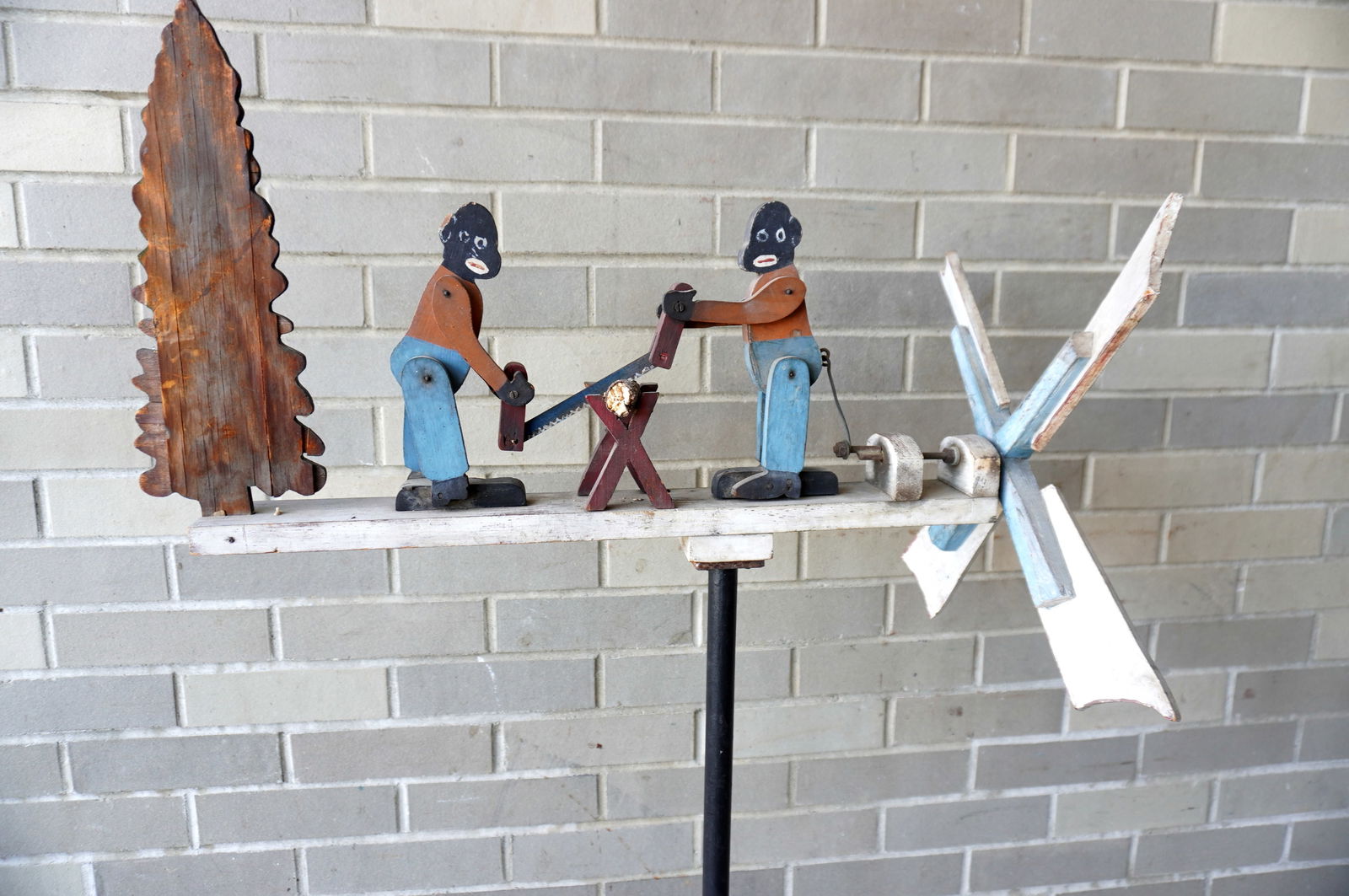 A folk art wooden whirligig of 2 Black men sawing log, in original paint. The log is a replacement, (1 of 9)