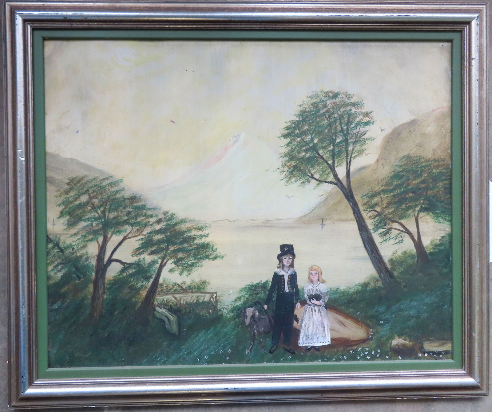 A folk art O/B depicting a young boy holding dog and young girl holding a cat, on hill with trees (1 of 4)