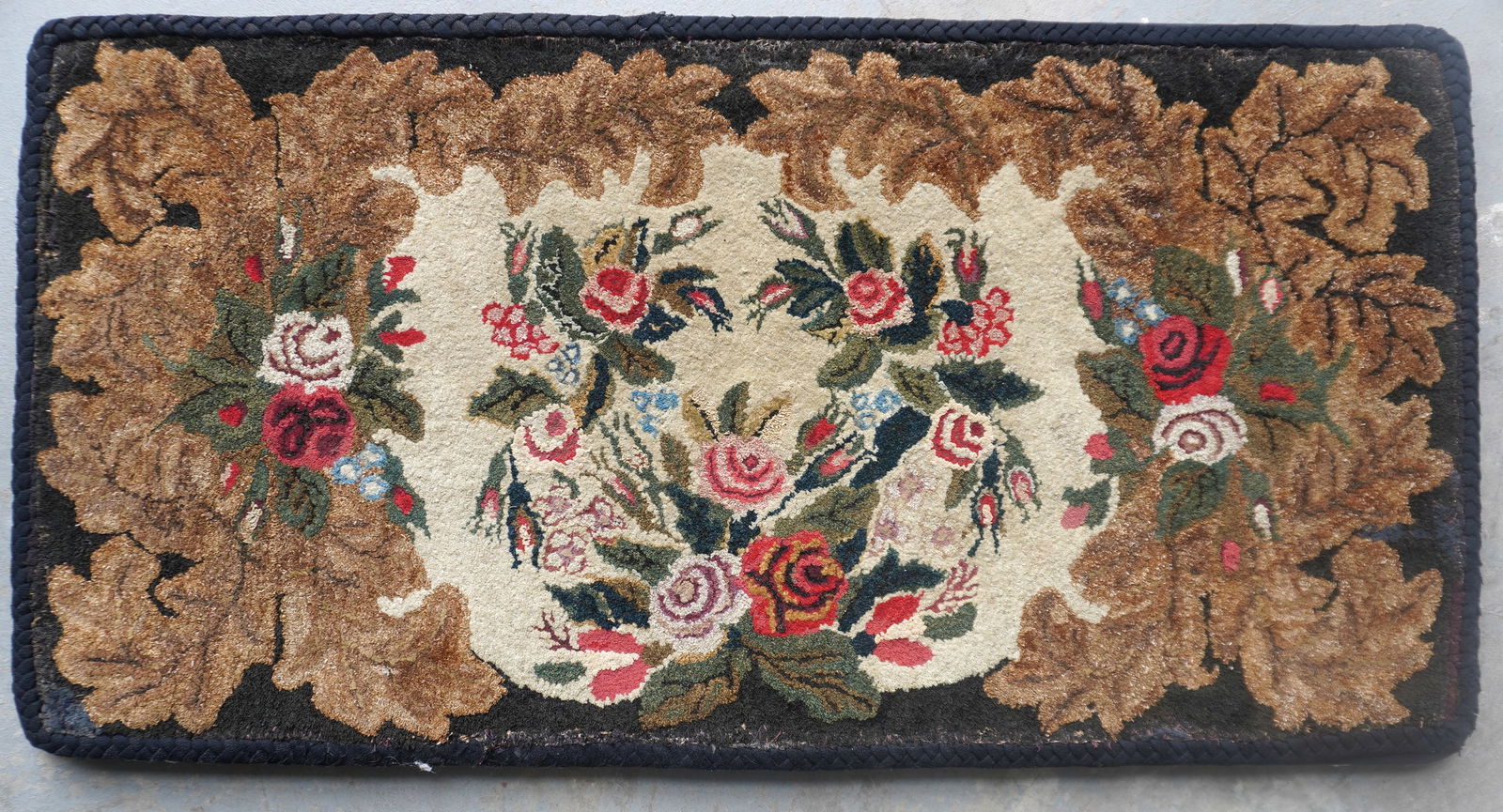 A good mounted Waldoboro (Maine) floral hooked rug with a braided border, 19th century - appears to (1 of 5)