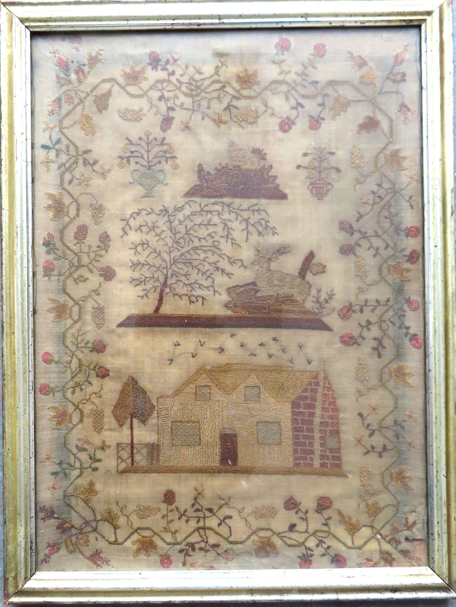 An early pictorial needlework sampler having a wide border of berries and leaves on vine, and having (1 of 7)