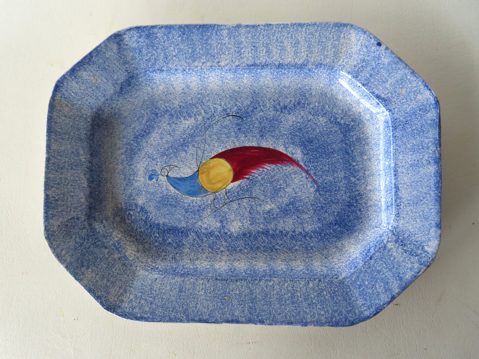 A blue spatterware octagonal platter in the peafowl pattern, 19th century - very good condition, no: A blue spatterware octagonal platter in the peafowl pattern, 19th century - very good condition, no damage. Measures 13 1/2" x 10 1/4". Provenance: From the Marni Bakst and William Sadler collection o