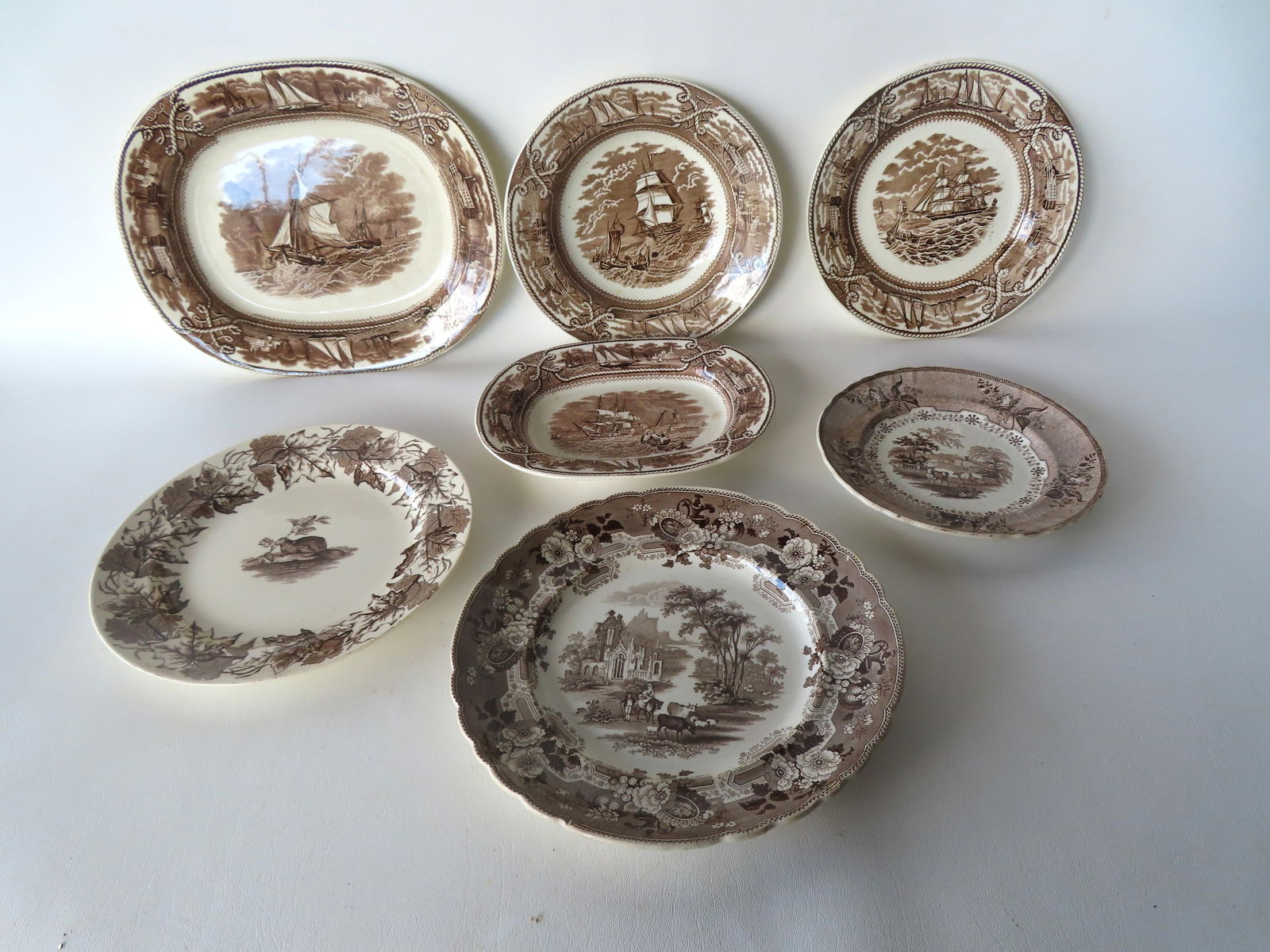 Grouping of 7 Staffordshire 19th century transferware plates and platters including: Brown and white (1 of 15)