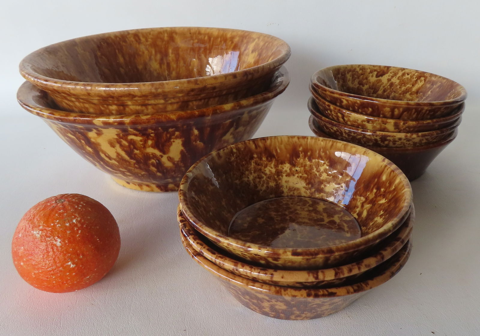 Grouping of 9 spongeware bowls, all 19th century. Includes 7 near matching bowls with the largest of: Grouping of 9 spongeware bowls, all 19th century. Includes 7 near matching bowls with the largest of these 6 7/8" diameter by 2"H - 2 with small rim chips, otherwise good condition; and 2 larger bowls