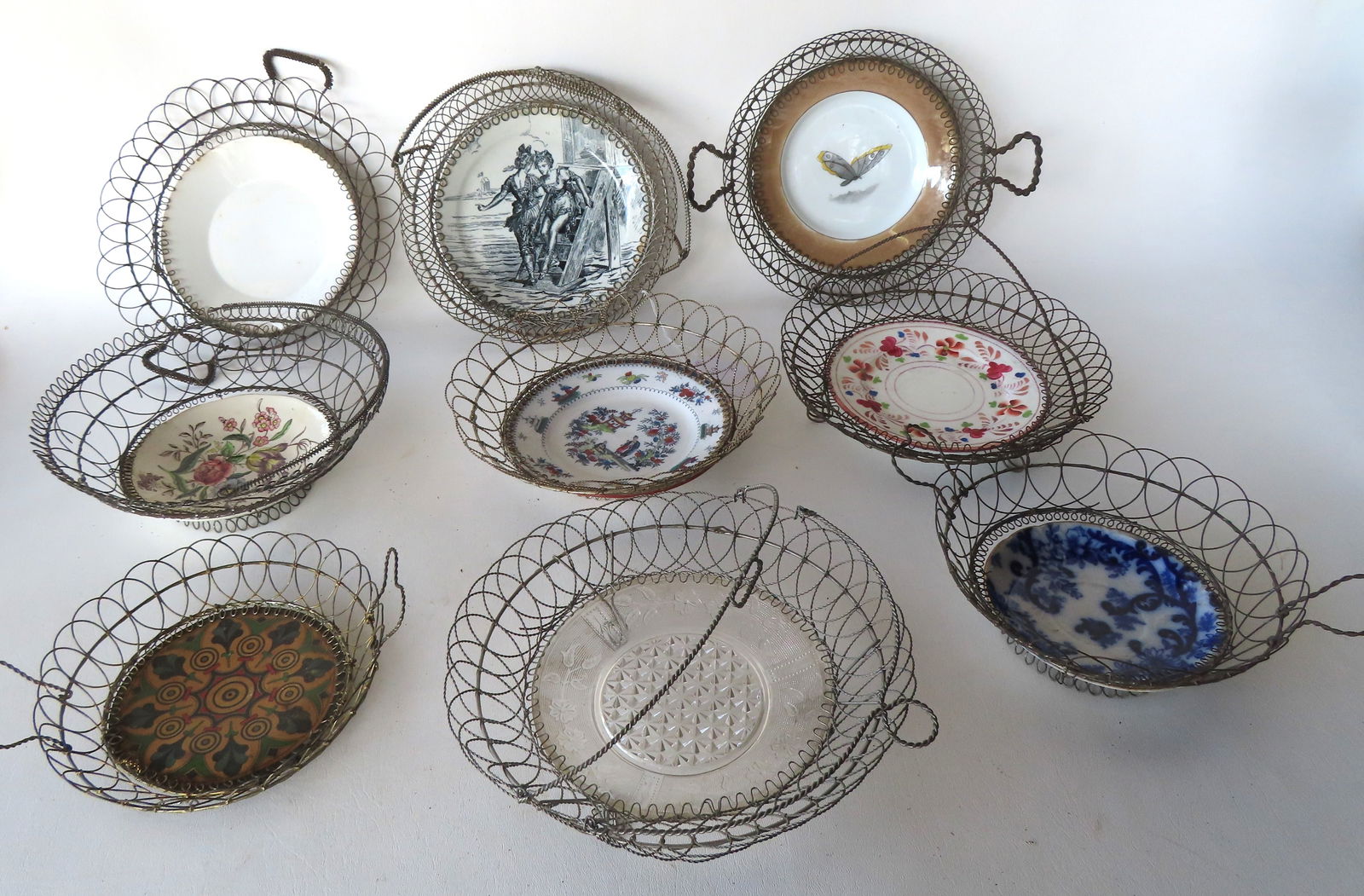 A grouping of 9 hand made wire baskets, all 19th century, 8 with vintage plates attached to base, (1 of 11)
