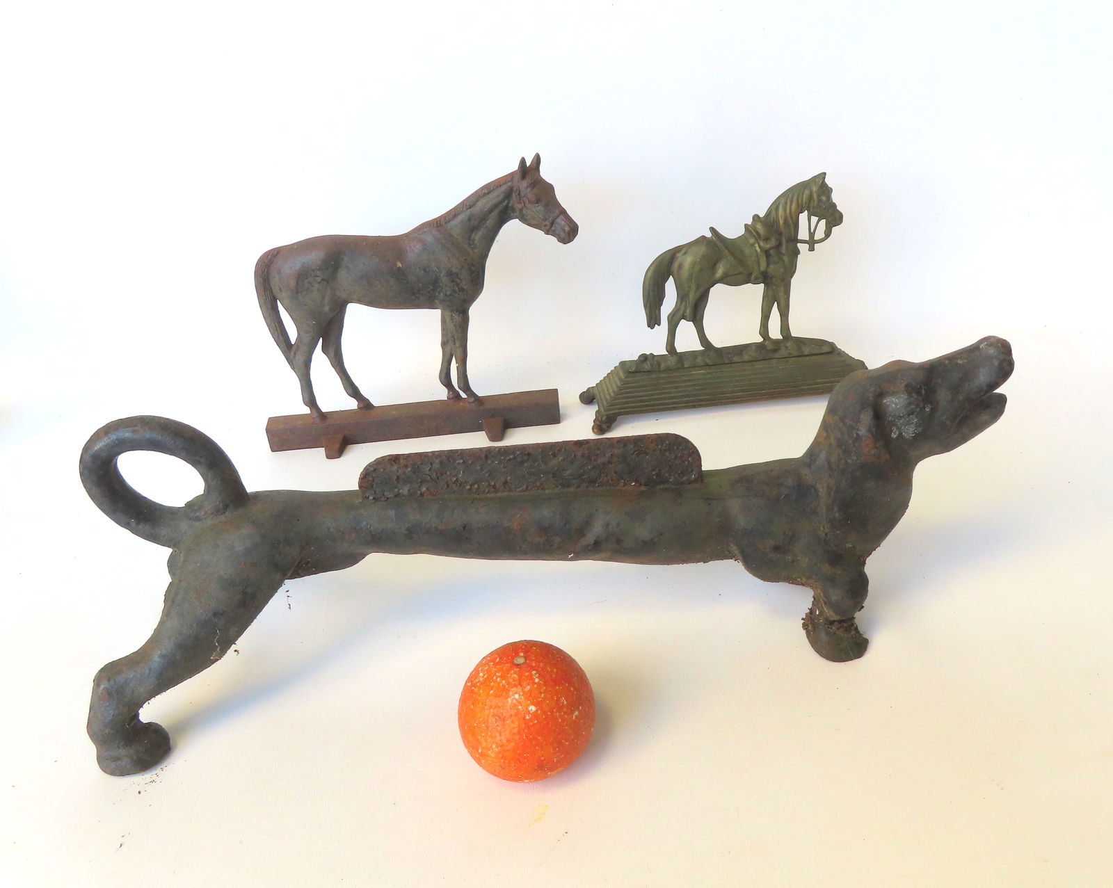 Two figural metal door stops and one cast iron boot scraper. Door stops includes a standing horse: Two figural metal door stops and one cast iron boot scraper. Door stops includes a standing horse marked "Copyright 1949 / VA. Metalcrafters / Waynesboro, VA." - traces of original black paint - the r