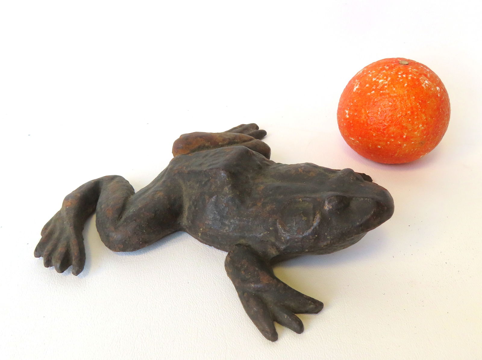 A life size cast iron bullfrog, either a door stop or figural garden ornament, traces of original: A life size cast iron bullfrog, either a door stop or figural garden ornament, traces of original paint, 19th century, very good condition - 7 1/2"D x 7 3/8"W 1 3/4"H.