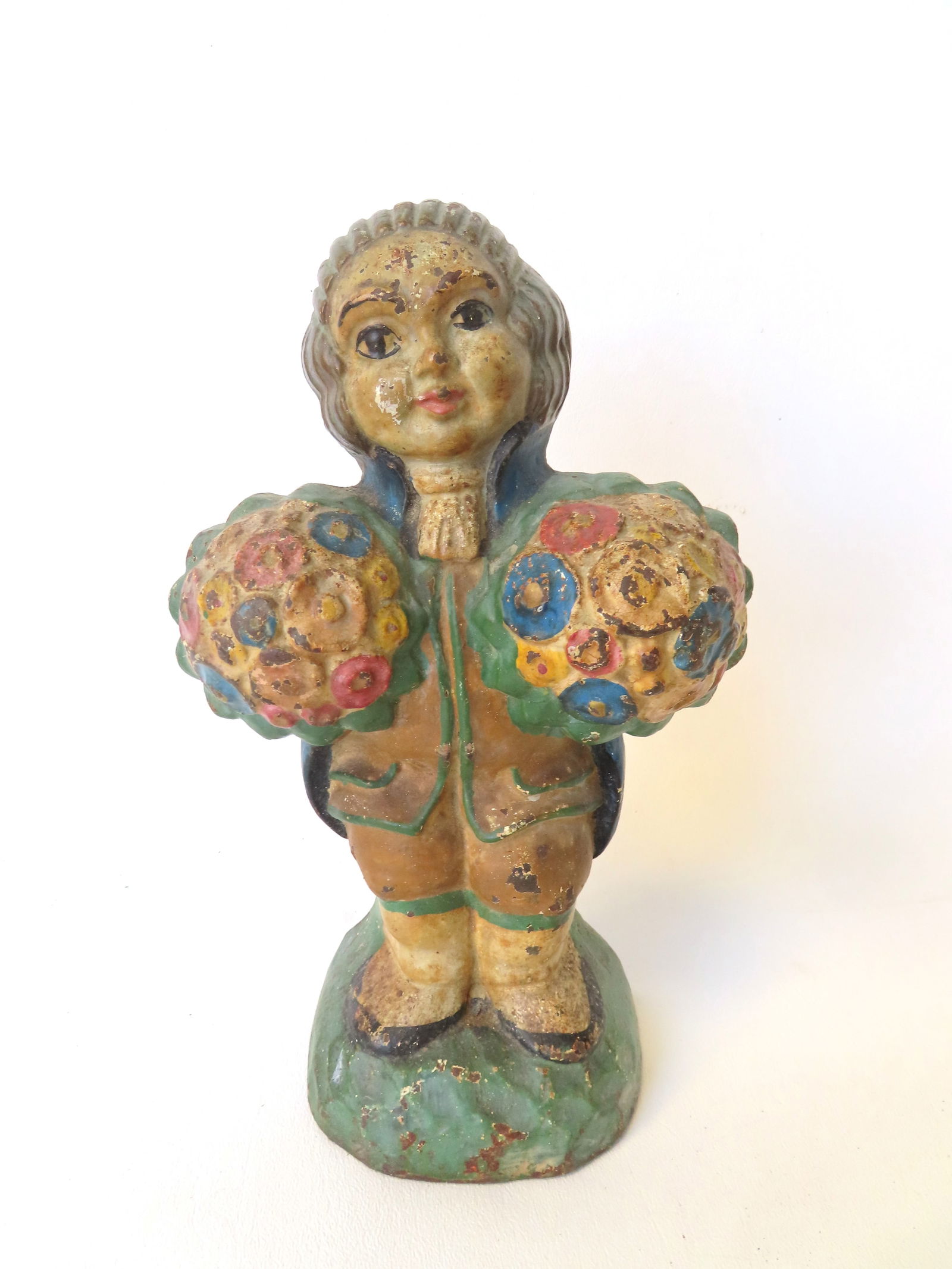 A Hubley cast iron door stop, colonial man holding flowers (titled "Man With Flowers" on: A Hubley cast iron door stop, colonial man holding flowers (titled "Man With Flowers" on Doorstops.com) , in original paint and in very good condition. Marked No. 821 on reverse side. Measures 9 1/8"H