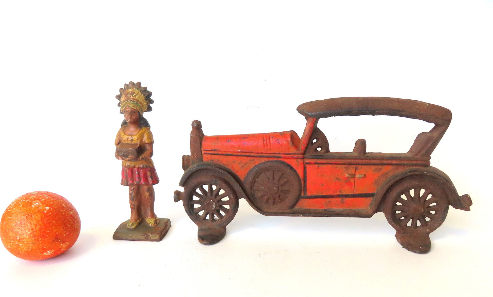 Two cast iron doors: The first a Ford automobile, silhouette form, early to mid 20th century - 12: Two cast iron doors: The first a Ford automobile, silhouette form, early to mid 20th century - 12 1/2"W x 5 3/4"H; and the second an Indian chief holding a box of cigars, probably a cigar store premiu