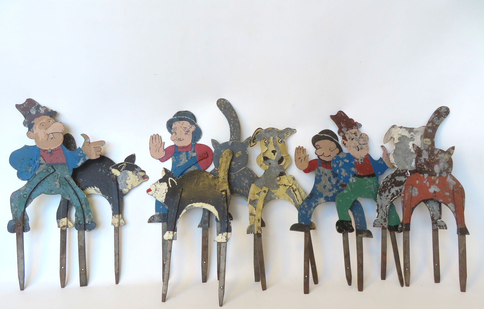 A grouping of 10 folk art galvanized sheet iron figural croquet wickets in original paint to: A grouping of 10 folk art galvanized sheet iron figural croquet wickets in original paint to include: Cats, dogs and whimsical men. All with paint losses and/or loose paint, but structurally sound, pr