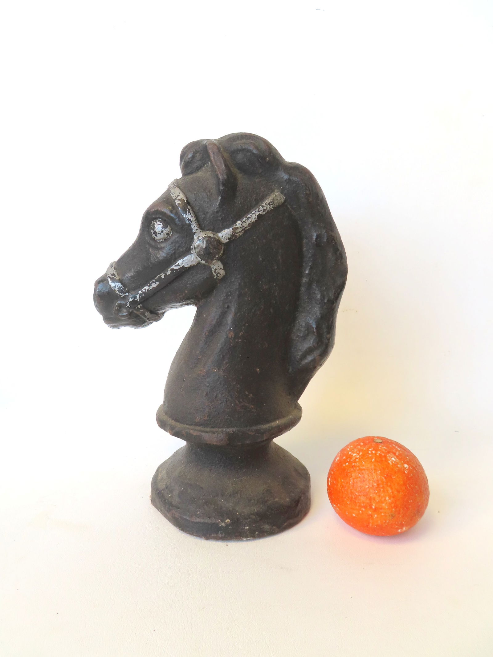 A solid cast iron horse head ornament, possibly for use as a trade sign, late 19th to early 20th: A solid cast iron horse head ornament, possibly for use as a trade sign, late 19th to early 20th century, in old black paint with grey harness. Very good condition. Measures 12"H x 8"W. Quite heavy an