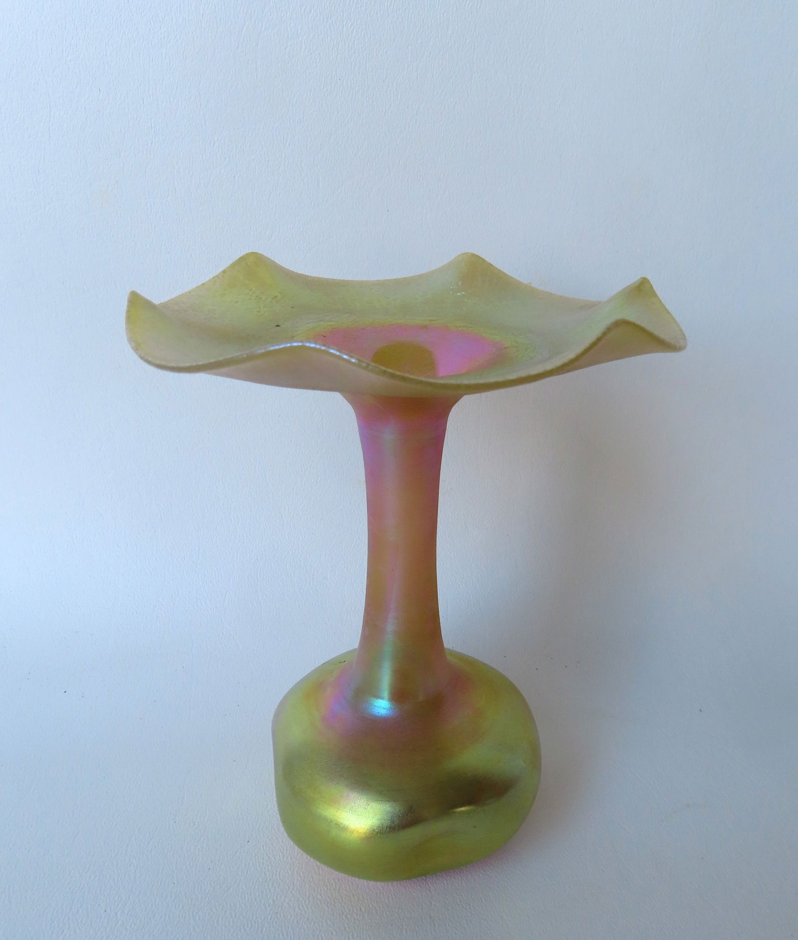 Steuben Aurene gold iridescent vase having a scalloped edge over long neck leading to bulbous: Steuben Aurene gold iridescent vase having a scalloped edge over long neck leading to bulbous pinched base, signed "Aurene 155", early 20th century. Measures 5 3/4"H x 4 5/8"W. Very good condition, no