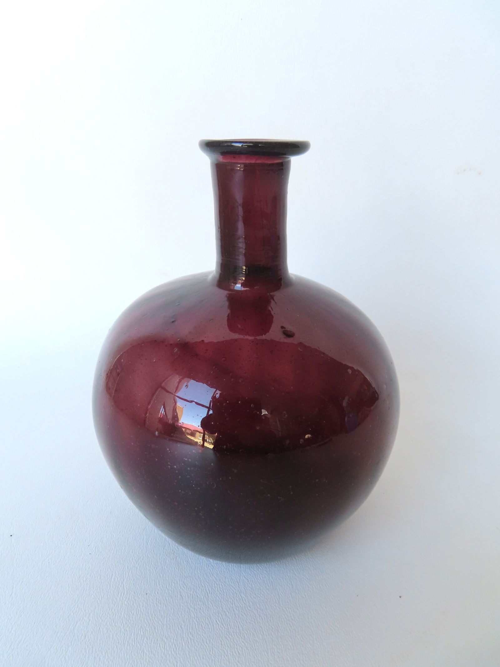 A globular slightly ribbed cranberry onion bottle with flared rim, pushed up bottom with open (1 of 6)