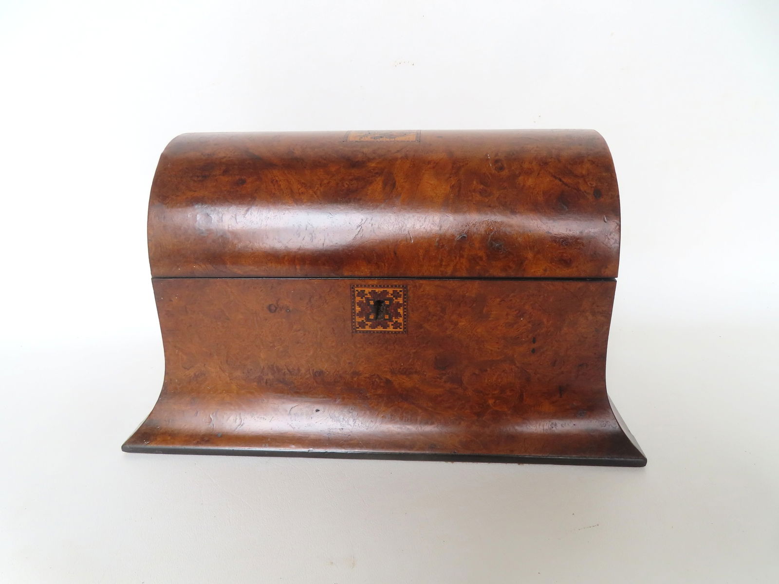 A burlwood veneered dome-top tea caddy having a mosaic inlay on the lid depicting a bird perched on: A burlwood veneered dome-top tea caddy having a mosaic inlay on the lid depicting a bird perched on branch with leaves (very fine detailed work) - the escutcheon also with a detailed mosaic inlay of f