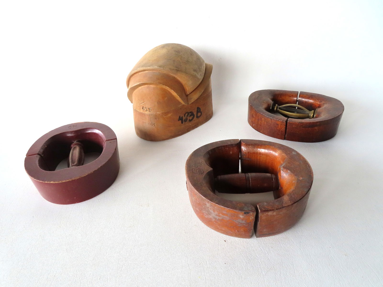 A very fine French sculptural wooden bonnet form/mold signed "Riva-Marchesi / Paris / Made in: A very fine French sculptural wooden bonnet form/mold signed "Riva-Marchesi / Paris / Made in France" - measures 6 3/4"H x 8 1/2"W - good condition; together with 3 hat stretchers (one signed J.T. Mas