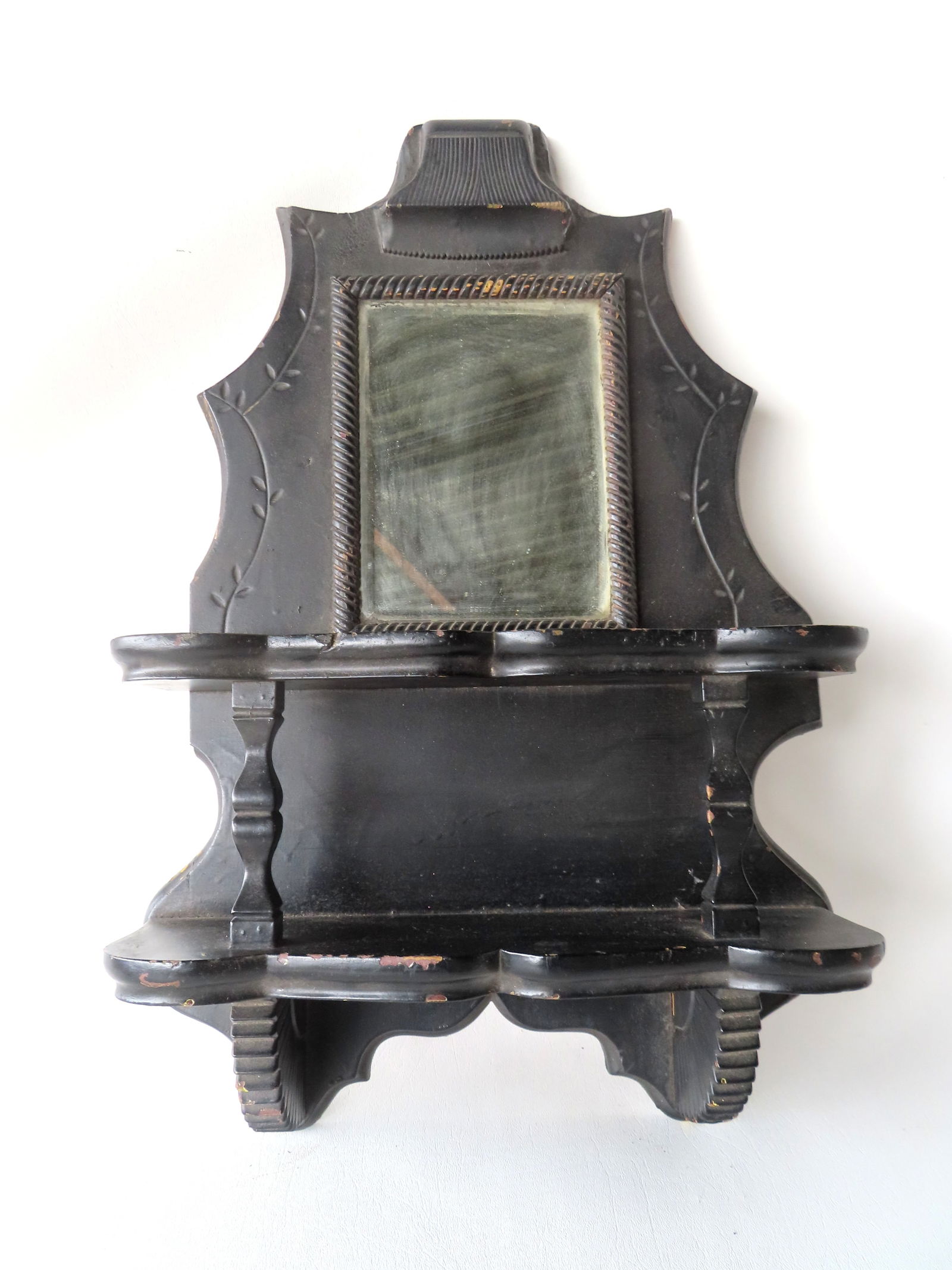 Ebonized Victorian wall shelf with mirror, 2 shaped shelves and chip carved border, late 19th: Ebonized Victorian wall shelf with mirror, 2 shaped shelves and chip carved border, late 19th century. Measures 15 3/4"W x 6"D x 24"H.