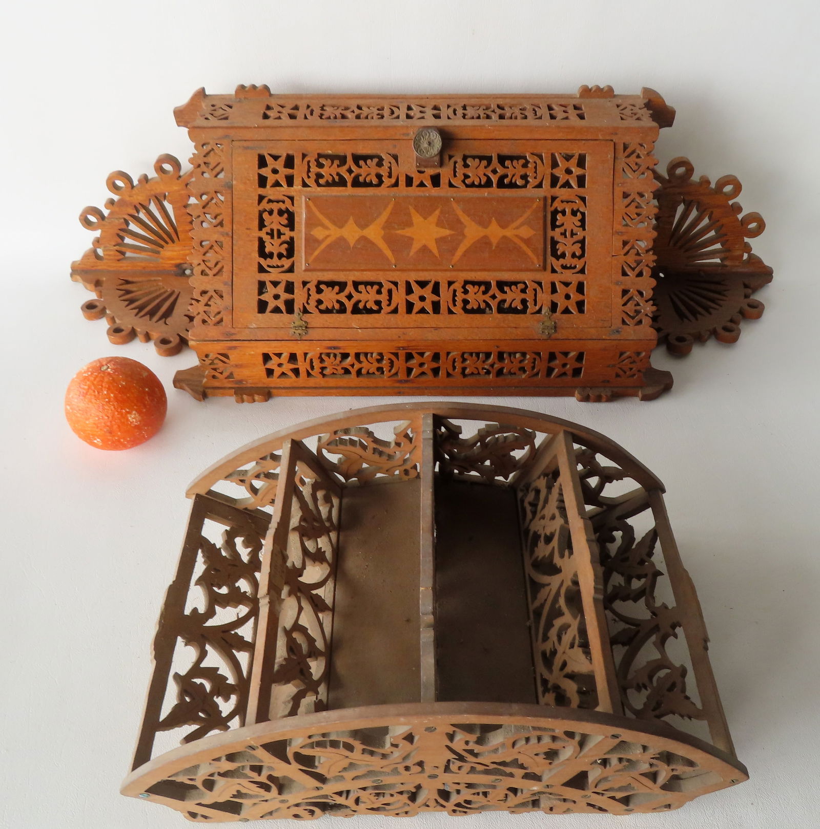 Two folk art fretwork collectibles including: A corner wall shelf with single door with star inlay -: Two folk art fretwork collectibles including: A corner wall shelf with single door with star inlay - the fretwork profusely decorated with stars and flowers, late 19th century - 27 1/2"H x 11"W x 8"D