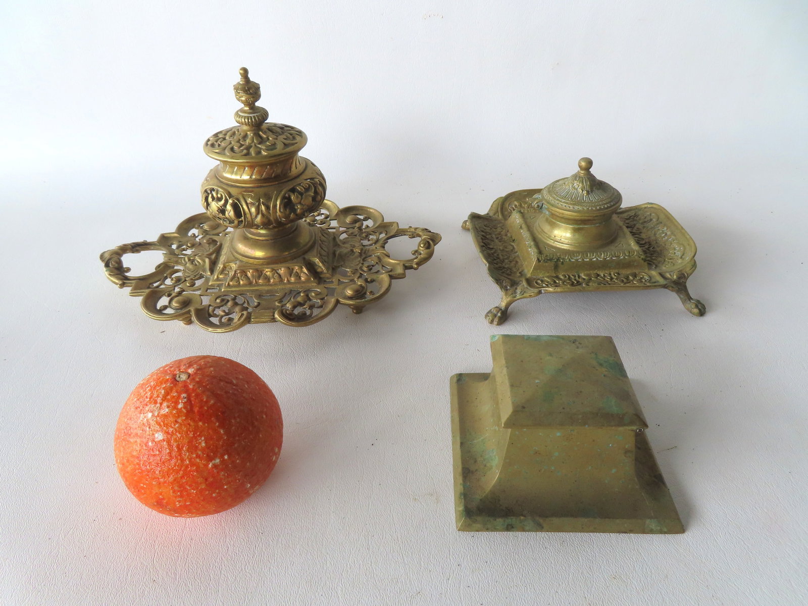 Three brass inkwells, all circa 1900-1930. The first in the mission style signed Bradley & Hubbard: Three brass inkwells, all circa 1900-1930. The first in the mission style signed Bradley & Hubbard with original milk glass insert - very good condition; and 2 fancy inkwells, the first with urn shape