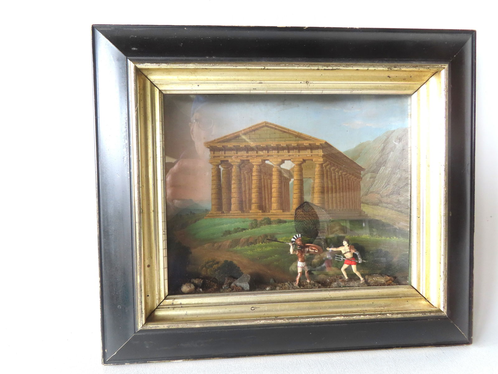 A diorama featuring a watercolor image of the Temple of Hera II in the background and 2 hand painted: A diorama featuring a watercolor image of the Temple of Hera II in the background and 2 hand painted composition figures of a gladiator fighting a Roman soldier in the foreground. The Temple of Hera I