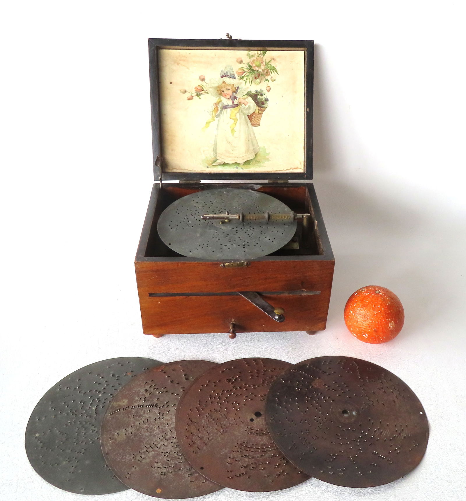 Small Fortuna disc table top music box signed my manufacturer "Schutz-Marke - Made in Germany",: Small Fortuna disc table top music box signed my manufacturer "Schutz-Marke - Made in Germany", serial number 32341. Comes with five 7" disks. Hand crank handle - the music box cranks and works fine b