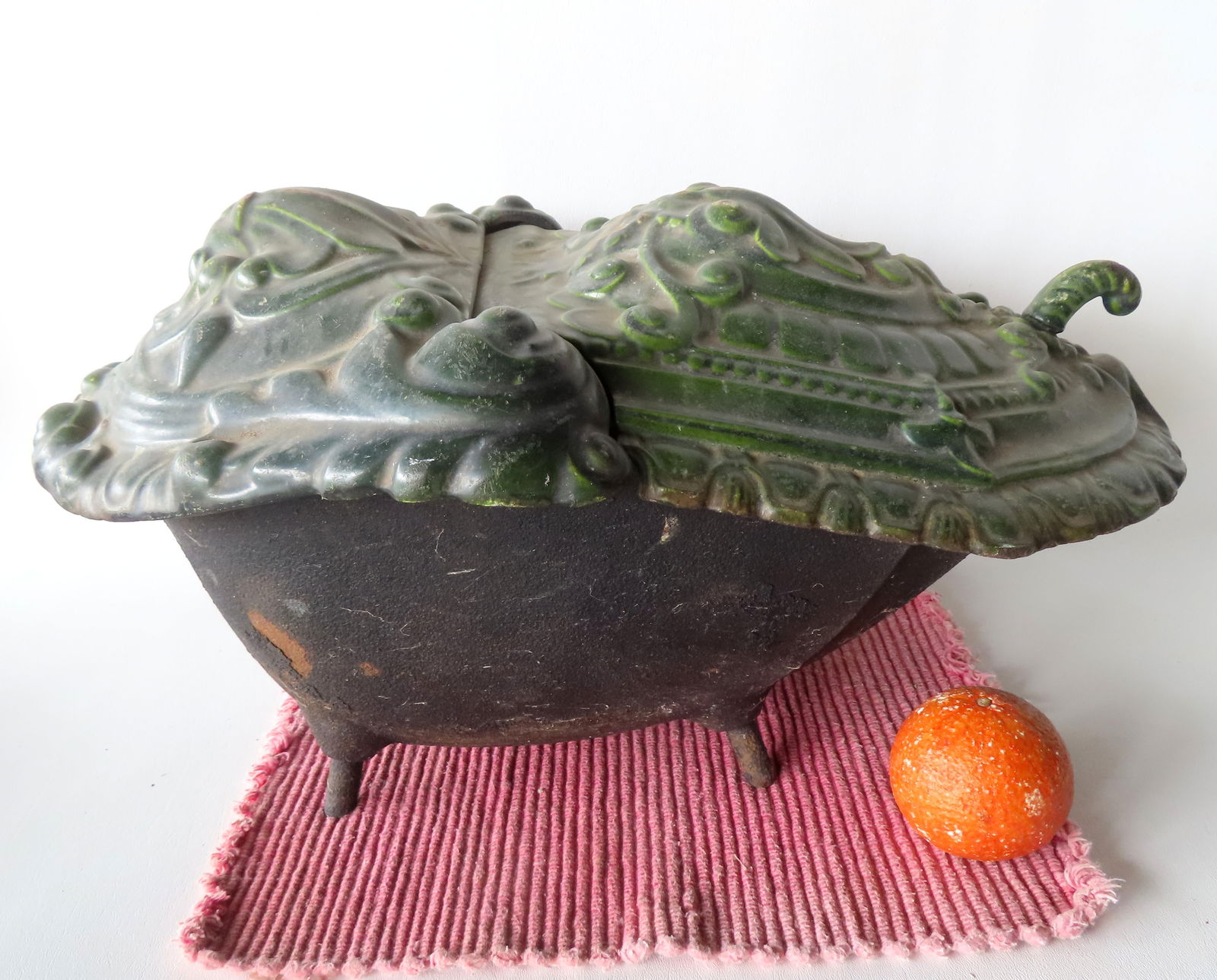 An unusual Belgium enameled cast iron footed coal scuttle with hinged top, 19th century, marked on: An unusual Belgium enameled cast iron footed coal scuttle with hinged top, 19th century, marked on underside of lid "1577 / Fondieres Nestor Martin" - measures 21"D x 13 1/2"W x 11"H - mounted on foot