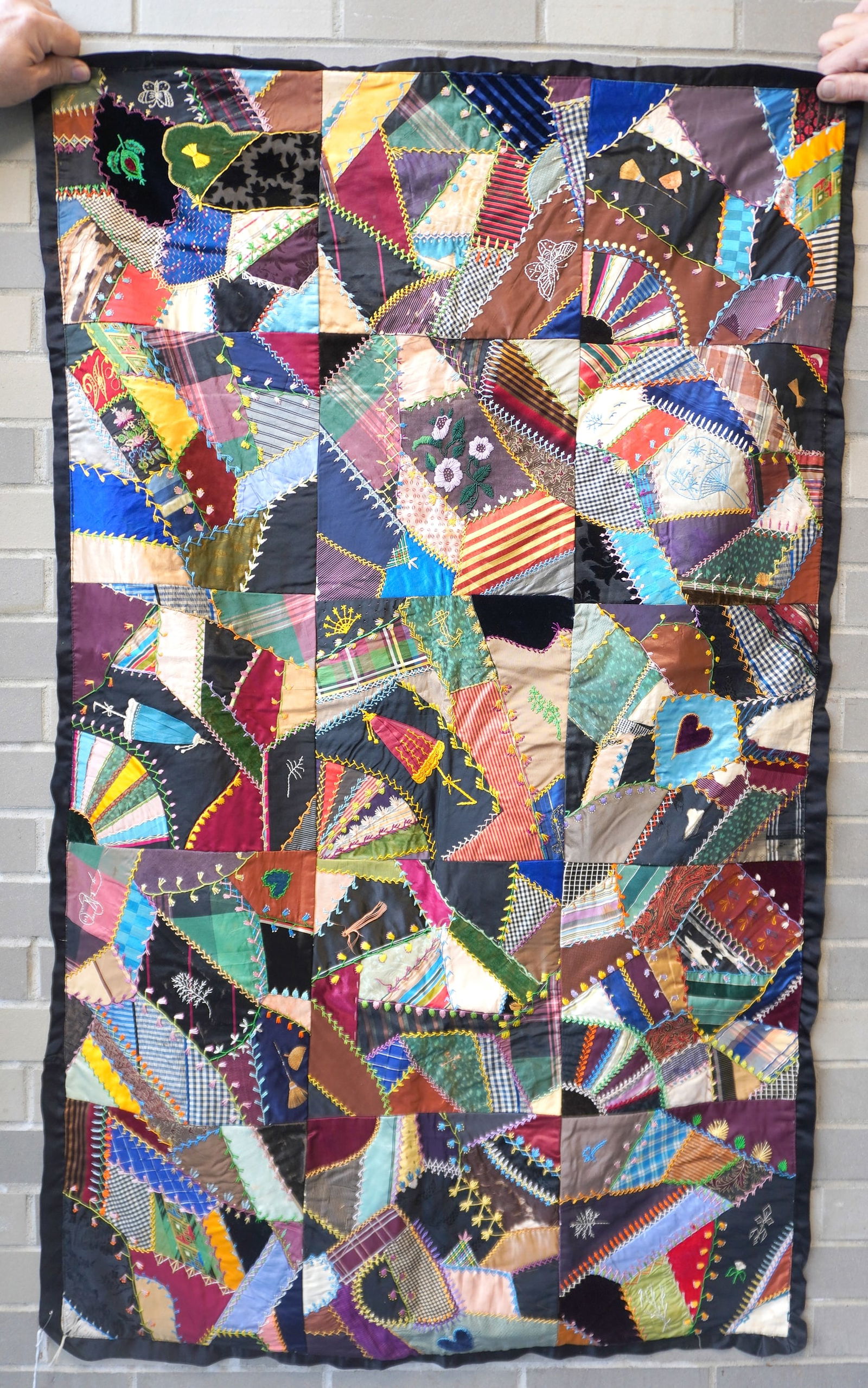 A small crazy quilt, currently being used as a wall hanging (fabric loops attached on reverse to (1 of 7)