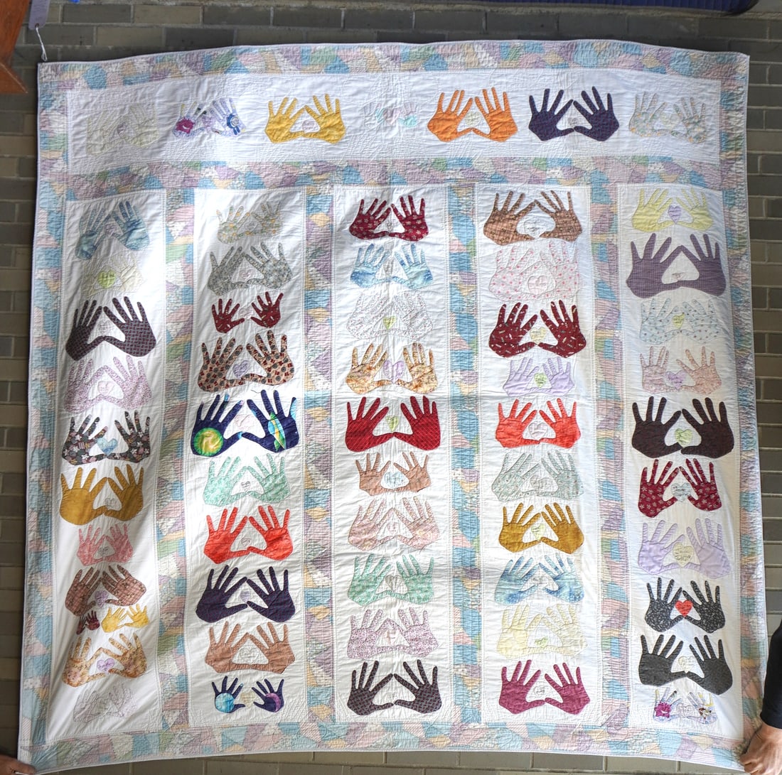 A Breast Cancer Awareness double sided Friendship quilt, machine sewn, won at a raffle in the: A Breast Cancer Awareness double sided Friendship quilt, machine sewn, won at a raffle in the Dutchess County Fair in Rhinebeck NY, many years ago. It is decorated with many double hands, including ch