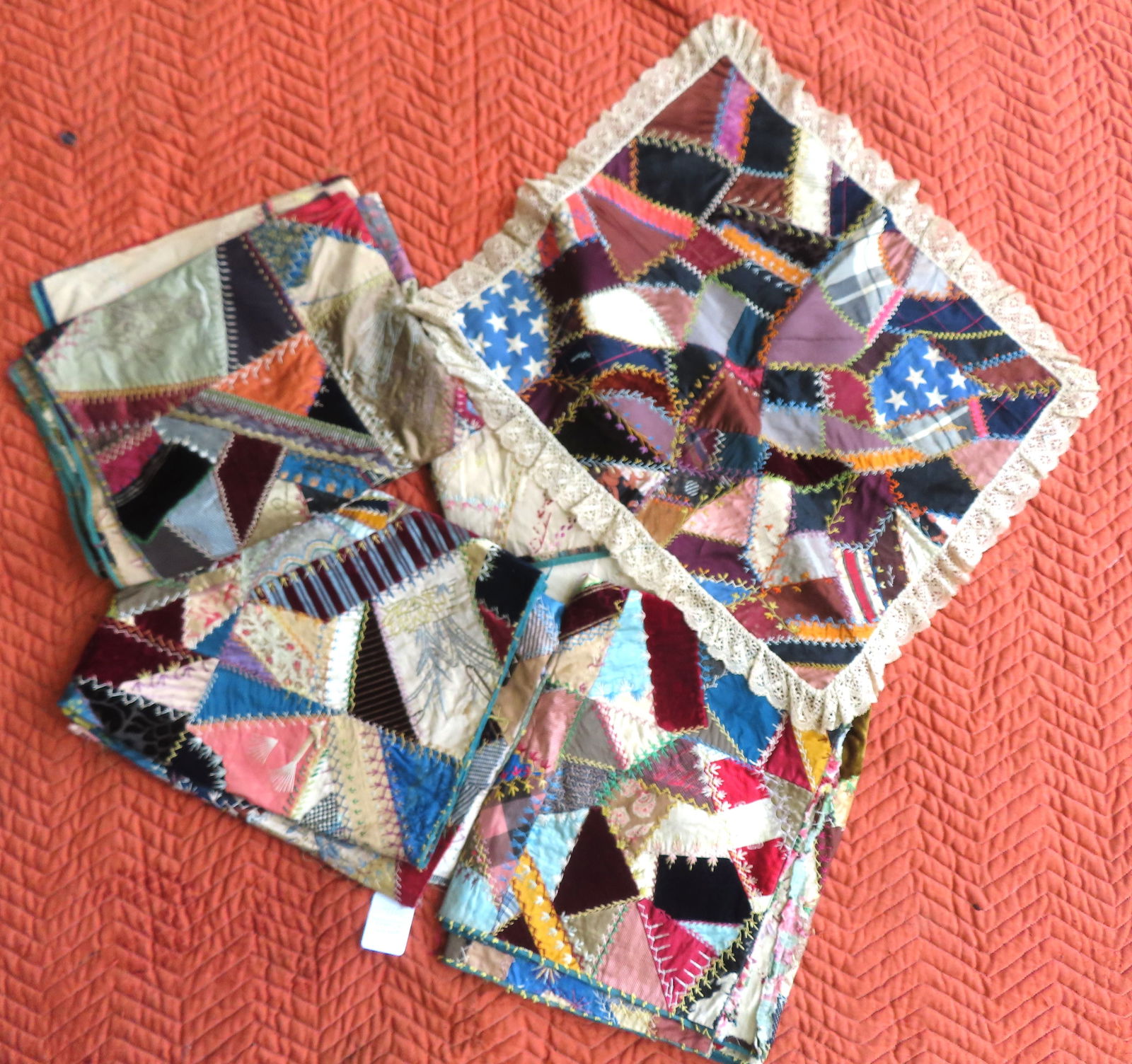 A grouping of crazy quilt sections plus crib quilt. The first section decorated with an angel, owl: A grouping of crazy quilt sections plus crib quilt. The first section decorated with an angel, owl on branch, flowers, etc. - several hardly noticeable frayed areas and overall good condition - measur