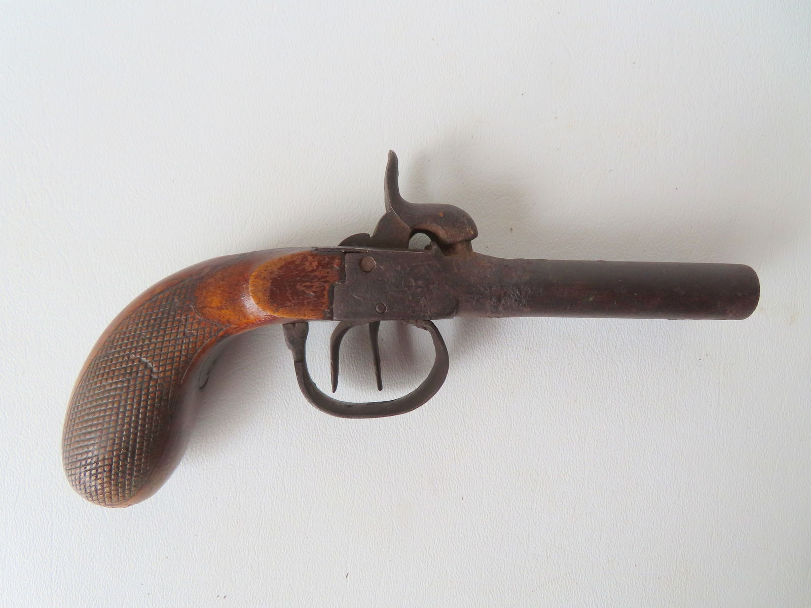 A percussion double barrel pocket pistol with engraved lock plate and having a checkered walnut (1 of 12)