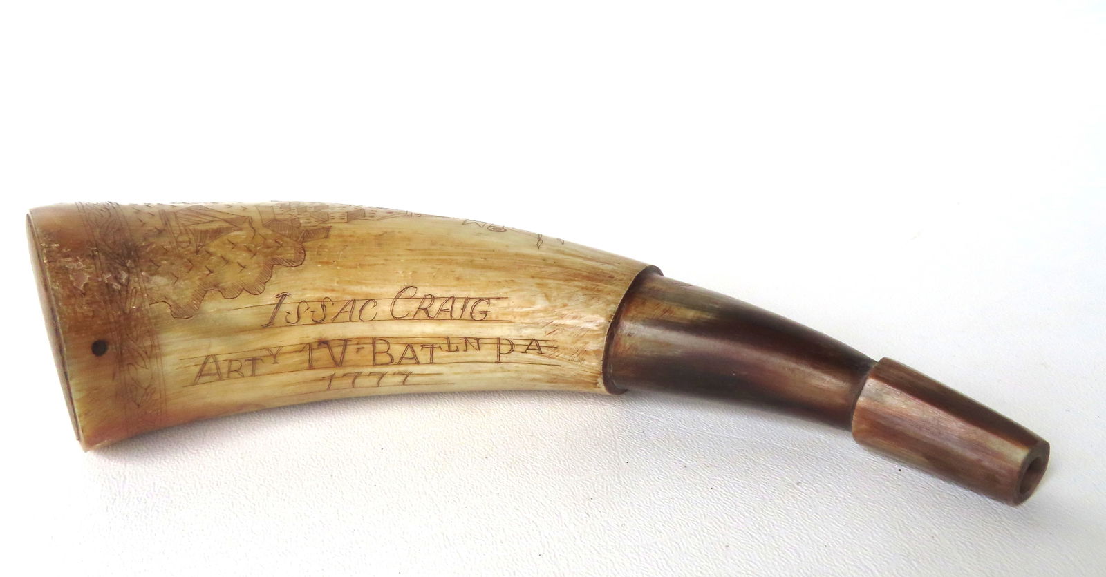 A scrimshaw powder horn engraved "Philadelphia" and dated 1777 and also marked "ISSAC CRAIG / ARTy: A scrimshaw powder horn engraved "Philadelphia" and dated 1777 and also marked "ISSAC CRAIG / ARTy IV BATln PA / 1777" (Isaac Craig, b. Ireland, d. USA, 1742–1826). The scrimshaw also includes an im