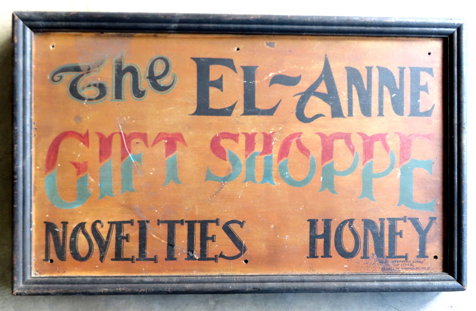 A hand painted store sign marked "The EL-ANNE GIFT SHOPPE / NOVELTIES HONEY", in original paint -: A hand painted store sign marked "The EL-ANNE GIFT SHOPPE / NOVELTIES HONEY", in original paint - Signed bottom right corner "Neal Stephen's Signs / Tel. WV 1556R or call at 4 Home St. W.P.". The sign