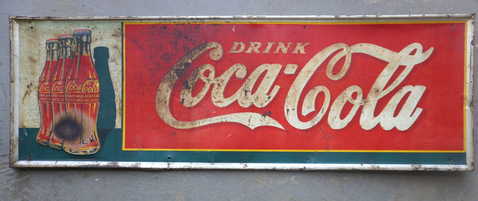 A vintage lithographed horizontal tin Coca Cola advertising sign with 3 bottles on the left side and (1 of 6)