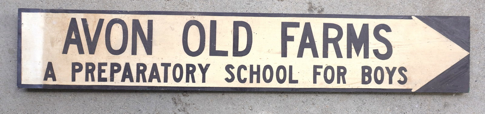 Wooden sign marked "AVON OLD FARMS / PREPARATORY SCHOOL FOR BOYS" painted on white ground arrow,: Wooden sign marked "AVON OLD FARMS / PREPARATORY SCHOOL FOR BOYS" painted on white ground arrow, circa 1950-70. Good condition. Measures 52"L x 9"H. Provenance: From the Marni Bakst and William Sadler