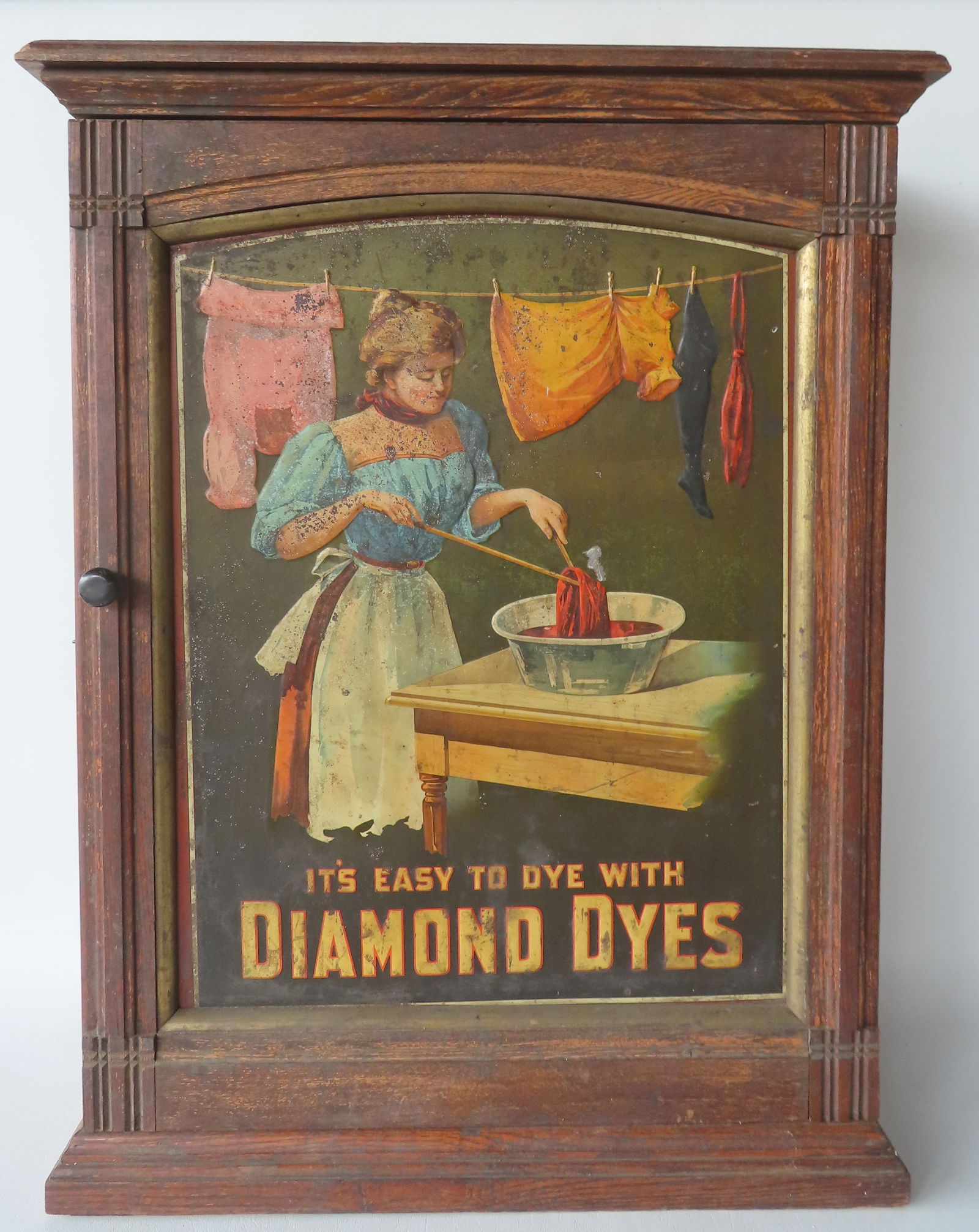 A Diamond Dye company oak country store display cabinet having a stepped molded base below its (1 of 9)