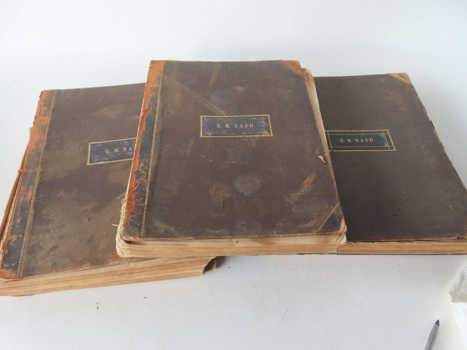 Grouping of 3 bound volumes of sheet music, circa 1850 - covers signed H.M. Nash. The volumes are: Grouping of 3 bound volumes of sheet music, circa 1850 - covers signed H.M. Nash. The volumes are worn with loose covers and losses to binding - the sheet music with some border foxing, minor staining