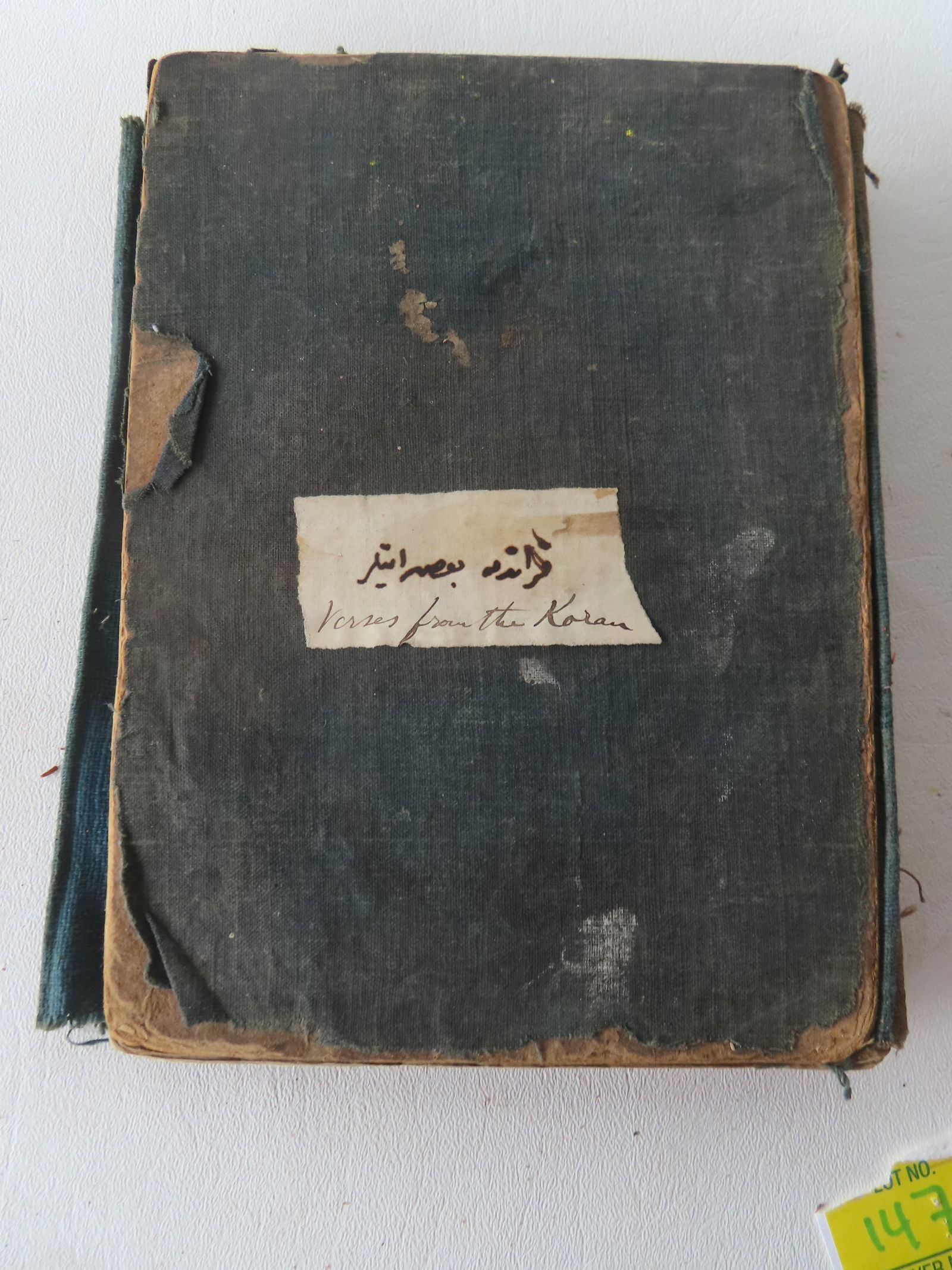 An Arabic book, translated on cover "Verses from the Koran", Arabic script in pen & ink, unsure of: An Arabic book, translated on cover "Verses from the Koran", Arabic script in pen & ink, unsure of age but likely 19th century. Loose binding, covers with wear and losses, page borders with discolorat