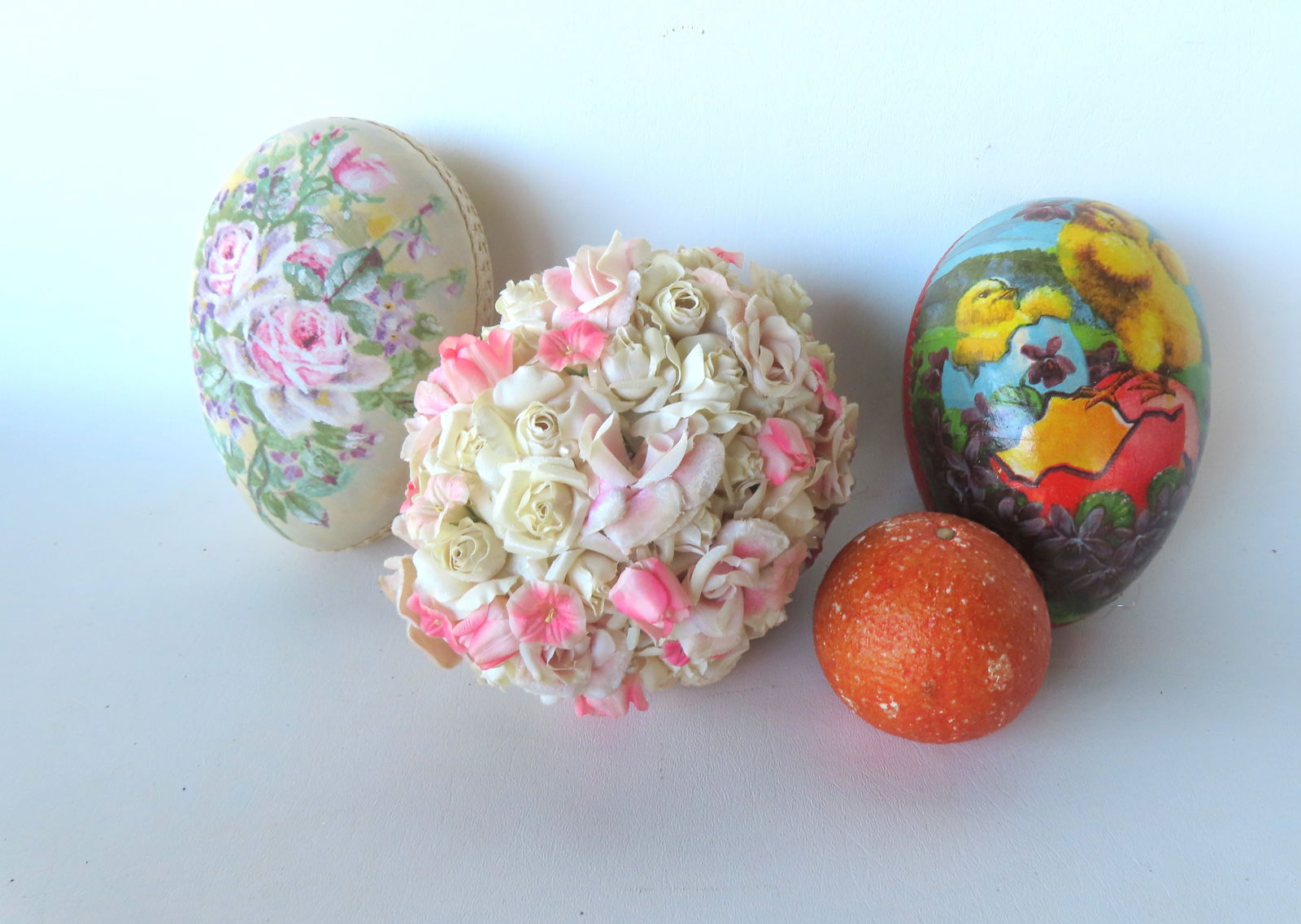 Three large faux Easter eggs. The first in cardboard wrapped in lithographed paper decorated with ch: Three large faux Easter eggs. The first in cardboard wrapped in lithographed paper decorated with chicks - good condition - measures approximately 6 1/2"L x 4 1/2"H; the second in cardboard wrapped in