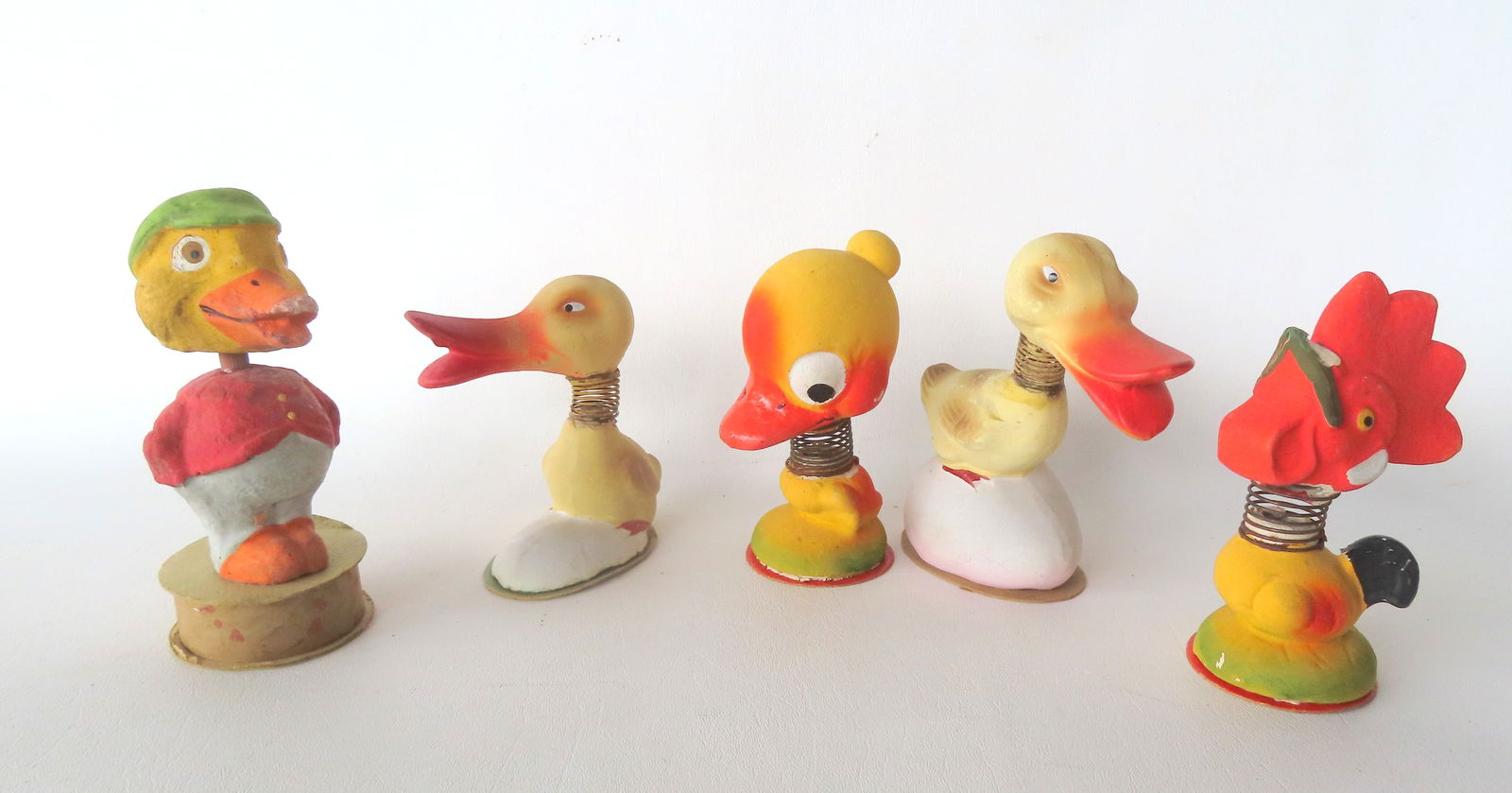 Five figural bobble head Easter ornaments and candy container, circa 1930-50, all believed to be Ger: Five figural bobble head Easter ornaments and candy container, circa 1930-50, all believed to be German. The rooster with paint chip on beak and the duck with green hat with wear on edge of beak, else
