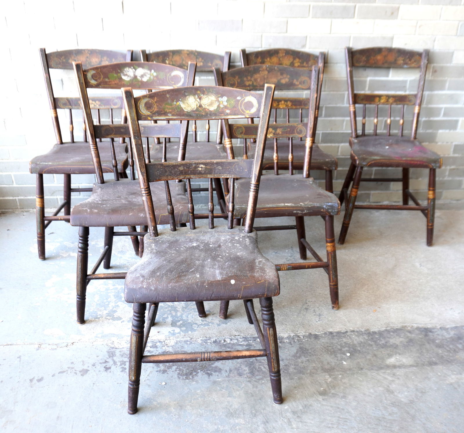Grouping of 7 stenciled and hand painted country chairs, 19th century.: Grouping of 7 stenciled and hand painted country chairs with half spindle back with double slats and shaped seats, circa 1830-50. Includes a matching set of 5 stenciled chairs with pin-striping that n